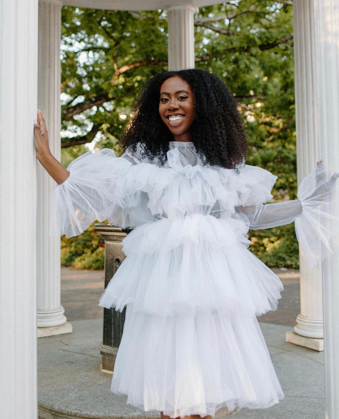 The Kayla Dress featuring soft fluffy ruffles and a zipper back, made from high-quality tulle, perfect for various occasions.