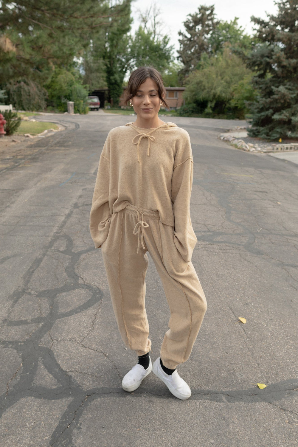 Kenny Hoodie in tan color featuring bell sleeves and a drawstring hood, made from organic cotton and recycled polyester.