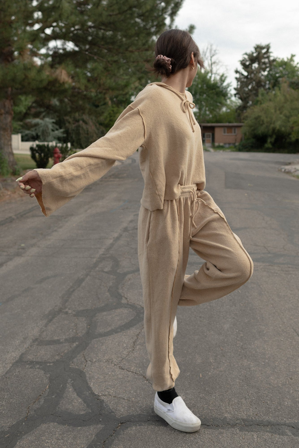 Kenny Hoodie in tan color featuring bell sleeves and a drawstring hood, made from organic cotton and recycled polyester.