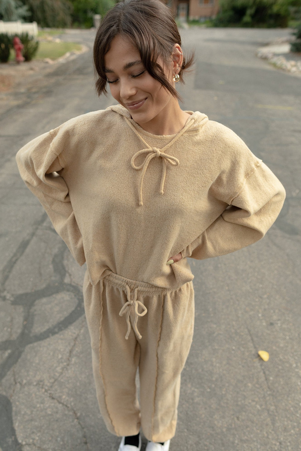 Kenny Hoodie in tan color featuring bell sleeves and a drawstring hood, made from organic cotton and recycled polyester.