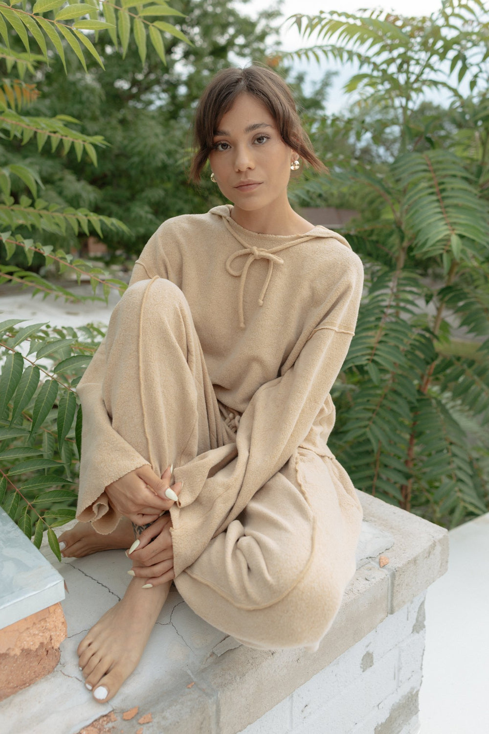 Kenny Pant in fleece tan color, featuring a drawstring waist, raw seam design, and pockets, styled with a matching top.