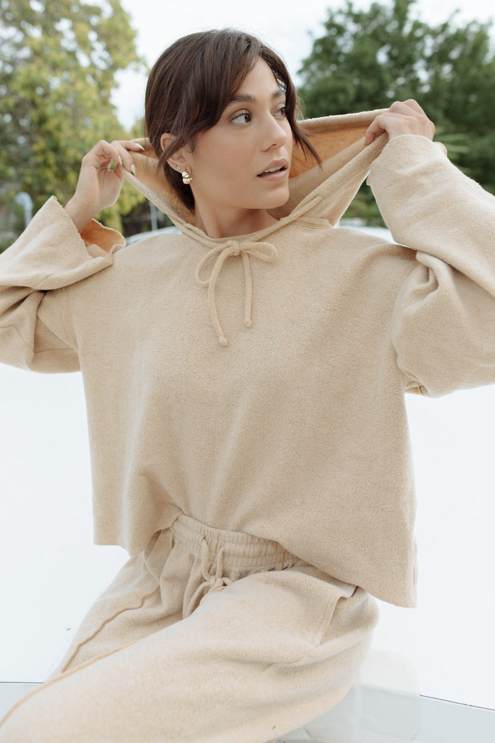 Kenny Pant in fleece tan color, featuring a drawstring waist, raw seam design, and pockets, styled with a matching top.