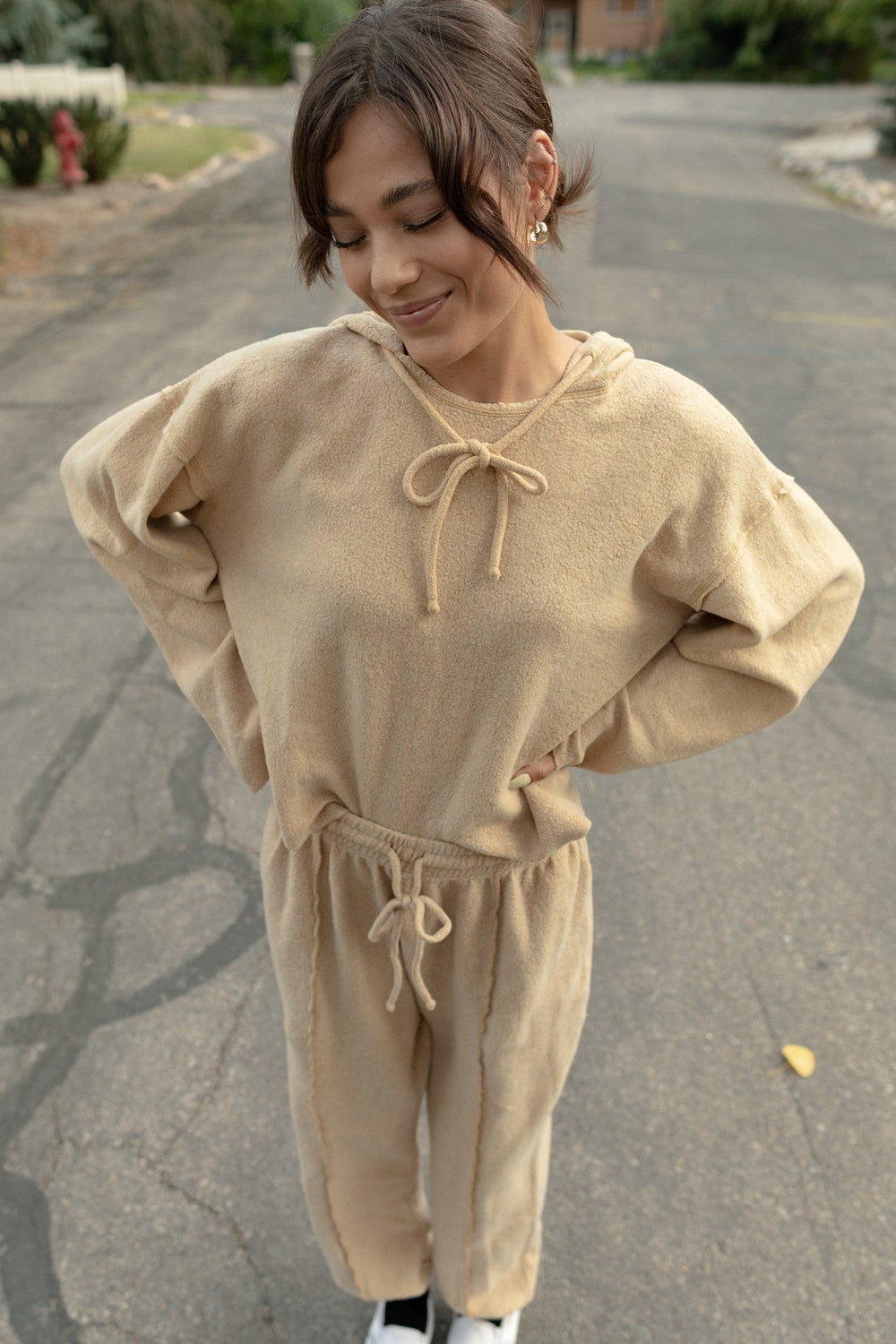 Kenny Pant in fleece tan color, featuring a drawstring waist, raw seam design, and pockets, styled with a matching top.