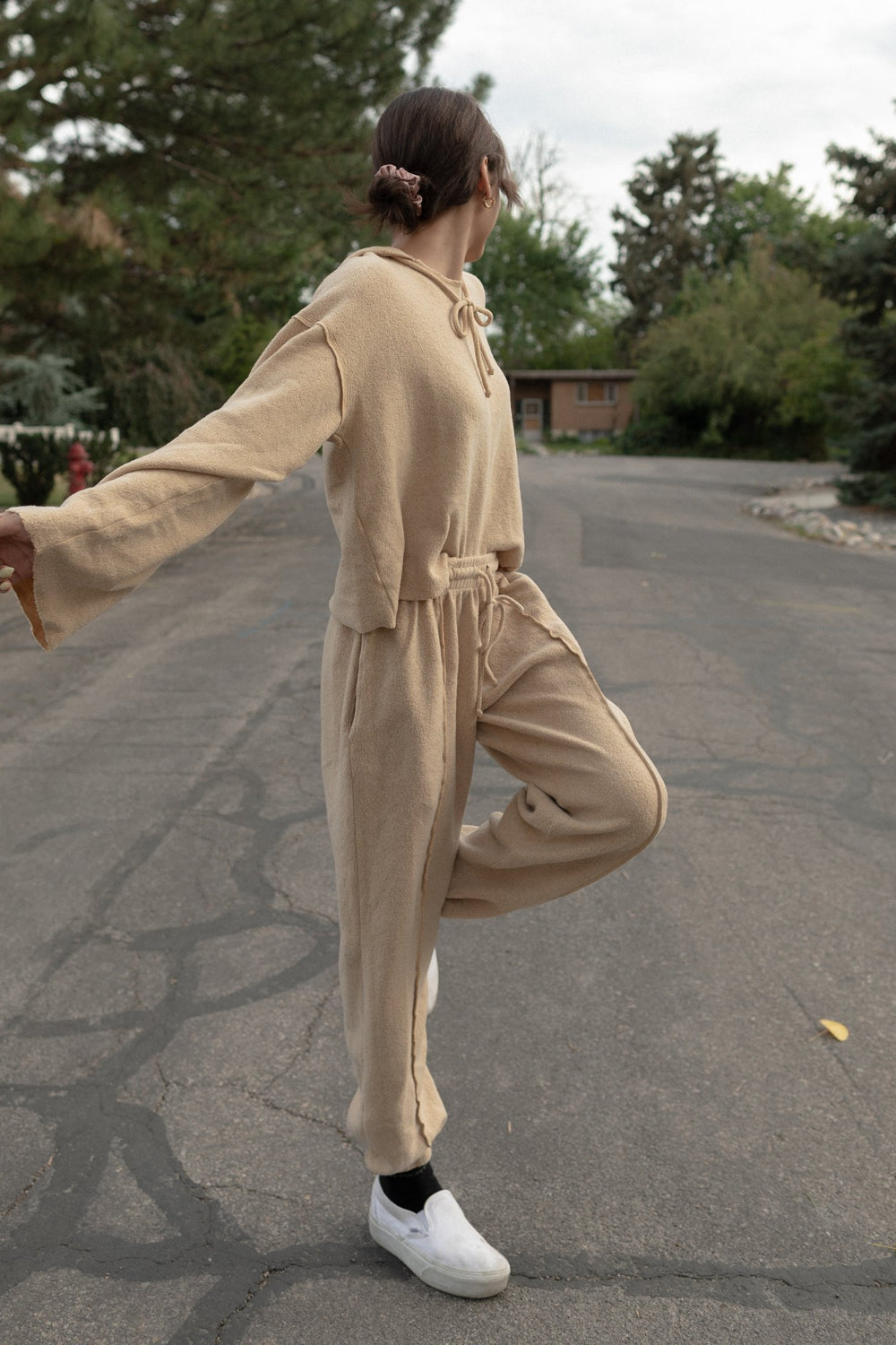 Kenny Pant in fleece tan color, featuring a drawstring waist, raw seam design, and pockets, styled with a matching top.