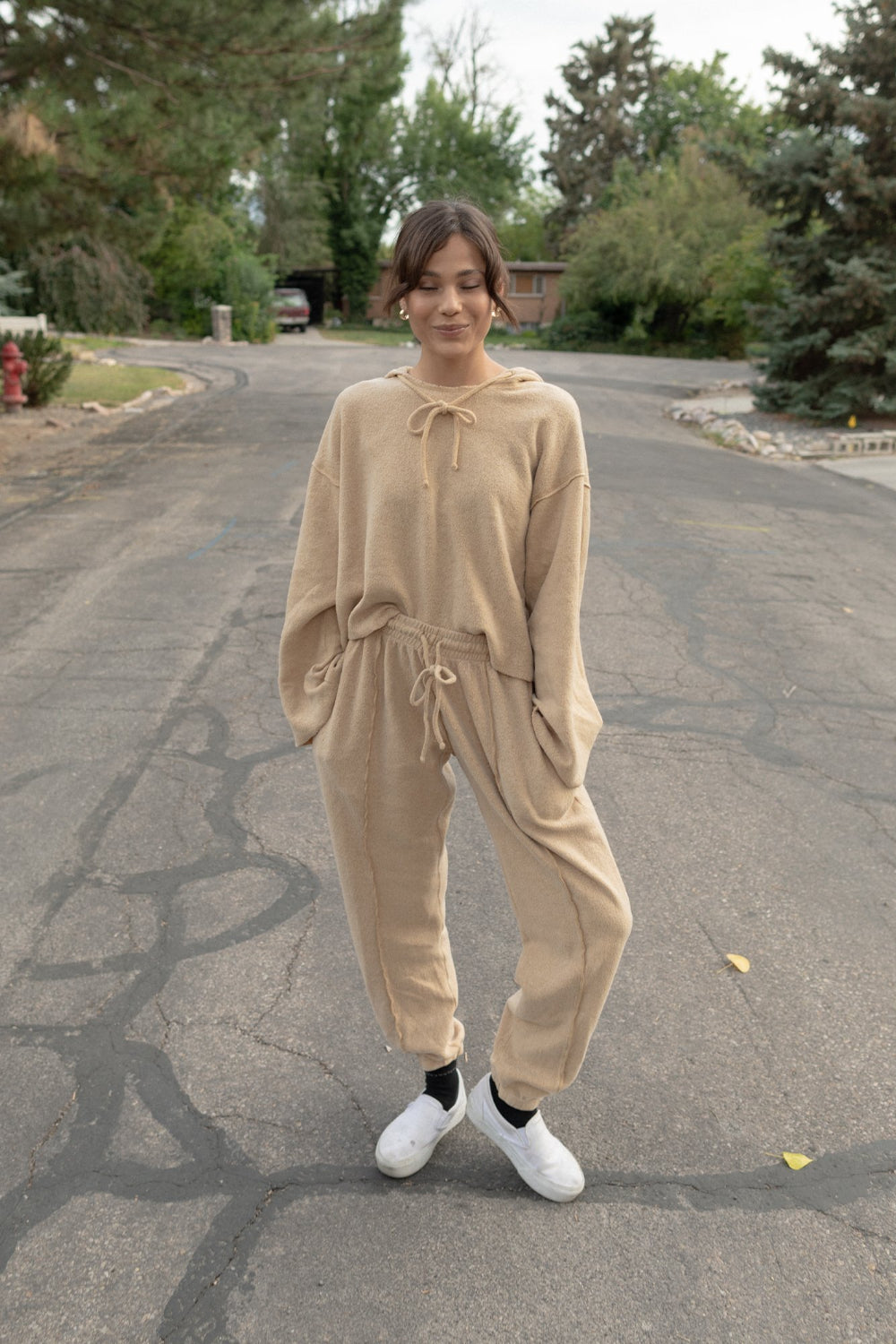 Kenny Pant in fleece tan color, featuring a drawstring waist, raw seam design, and pockets, styled with a matching top.