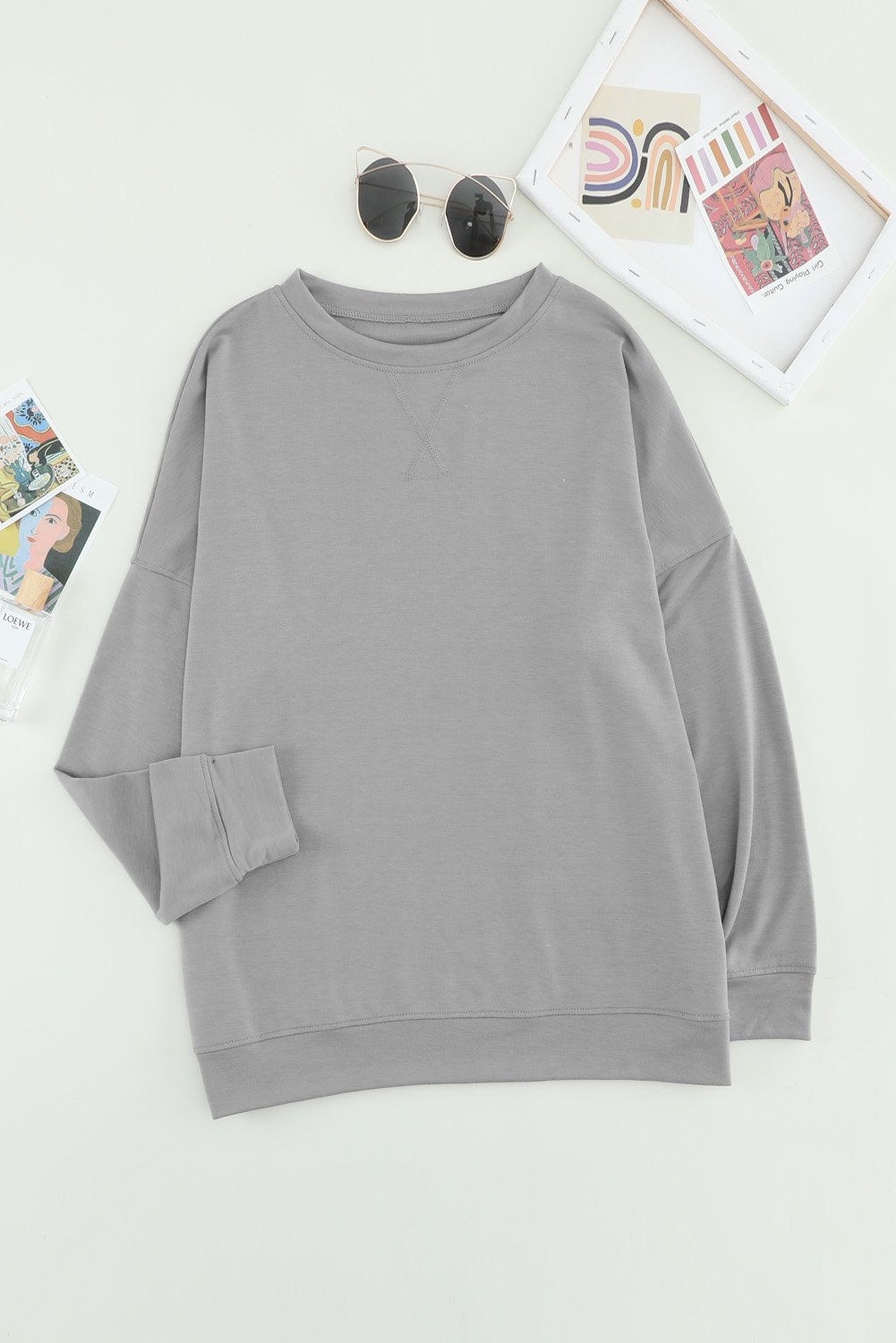 Khaki crew neck long sleeve sweatshirt displayed on a mannequin, showcasing its relaxed fit and stylish design.