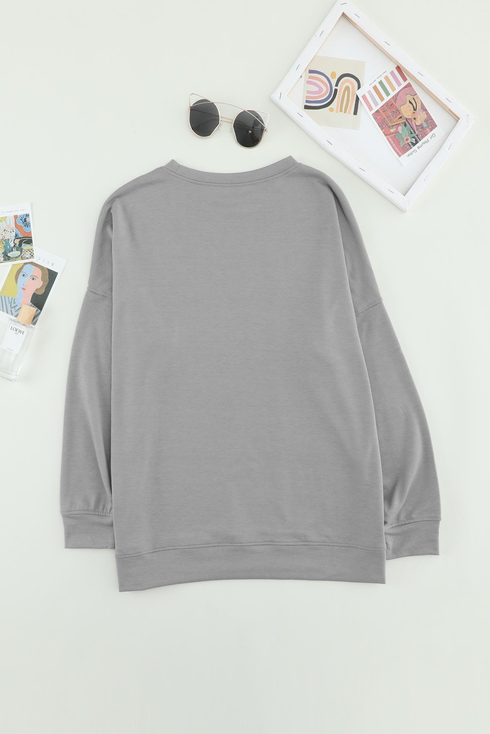 Khaki crew neck long sleeve sweatshirt displayed on a mannequin, showcasing its relaxed fit and stylish design.