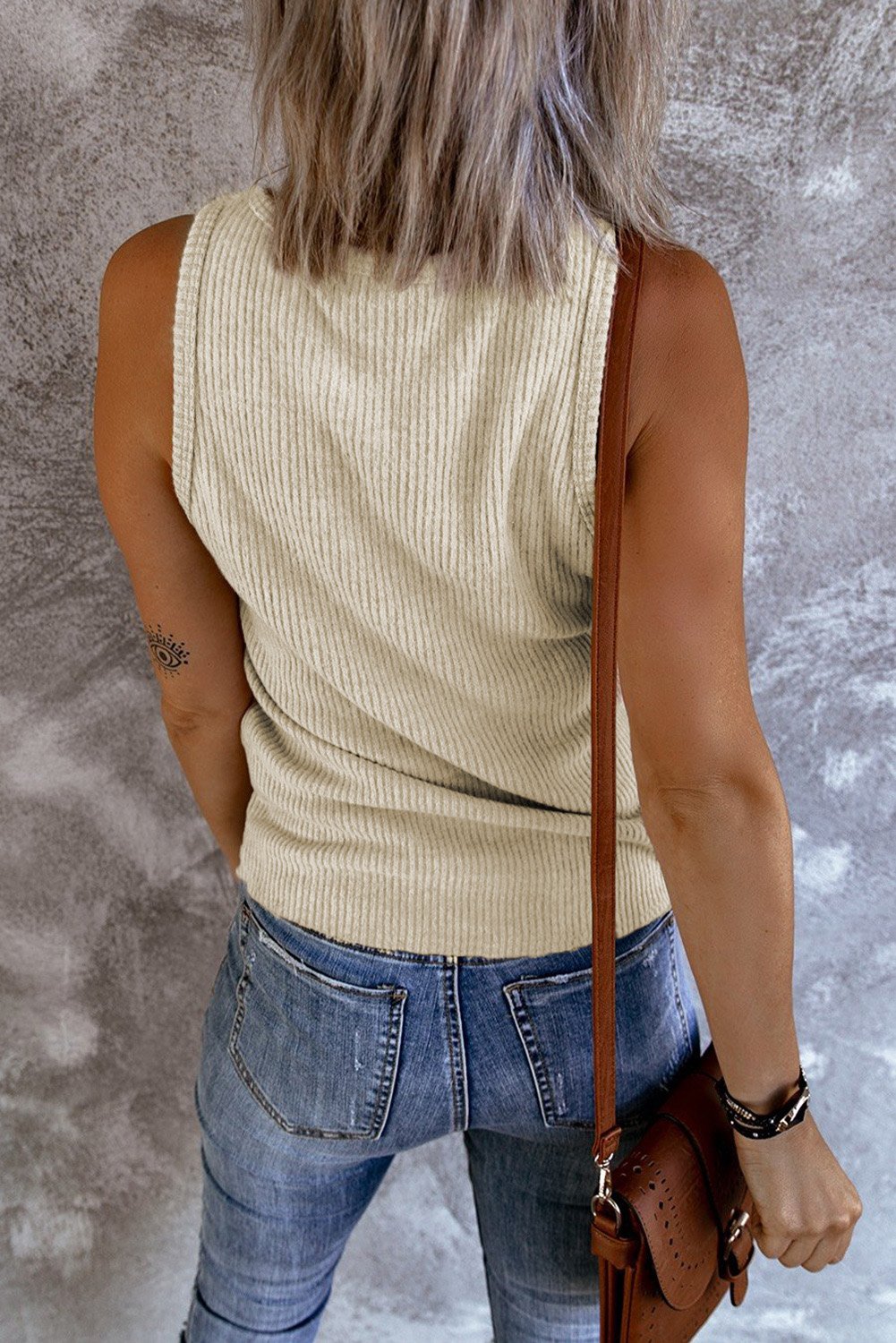 Khaki ribbed tank top displayed on a mannequin, showcasing its soft texture and neutral color, perfect for fall layering.