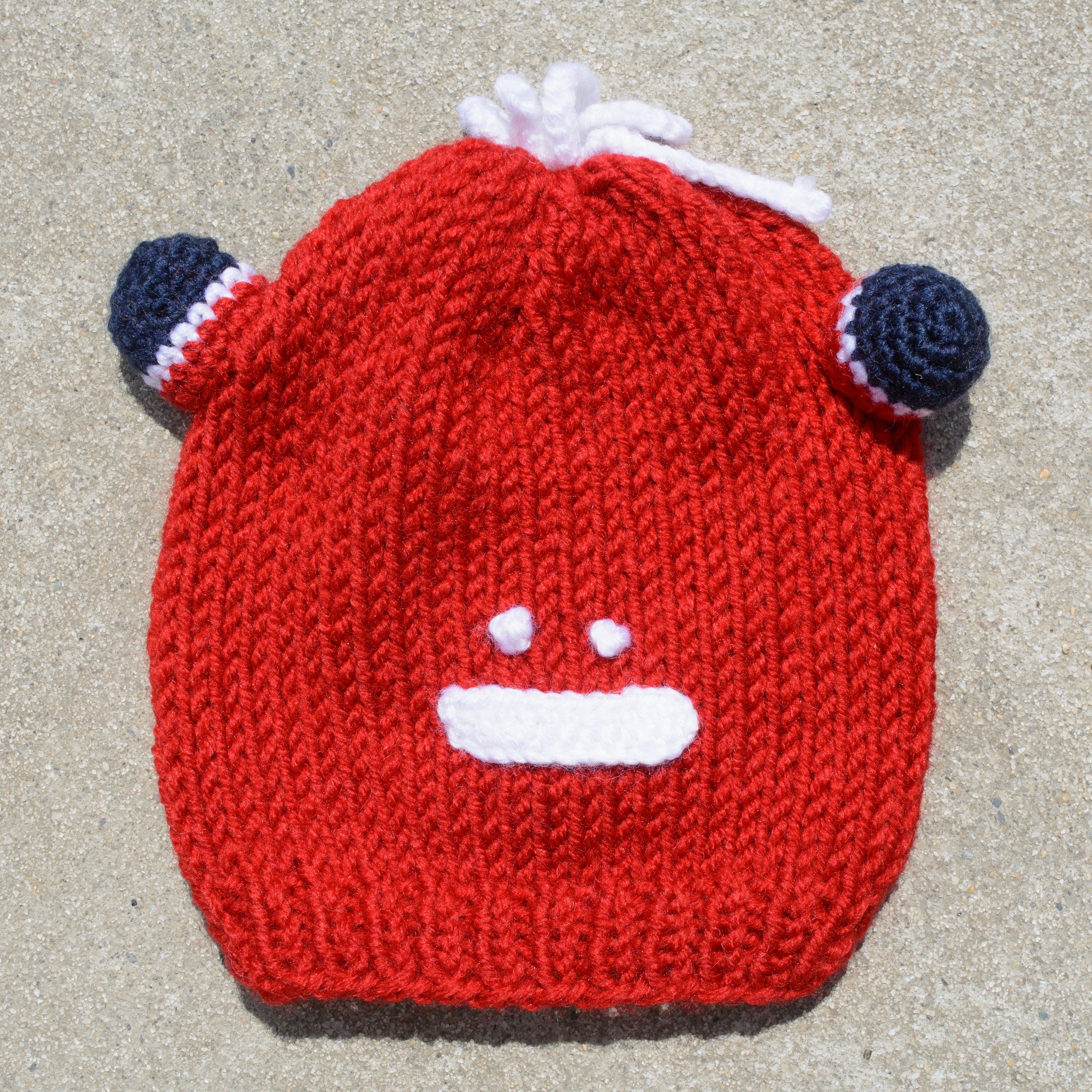 Hand-knitted frog wool beanie cap for kids, featuring a playful design and cozy fit, perfect for ages 2-7.