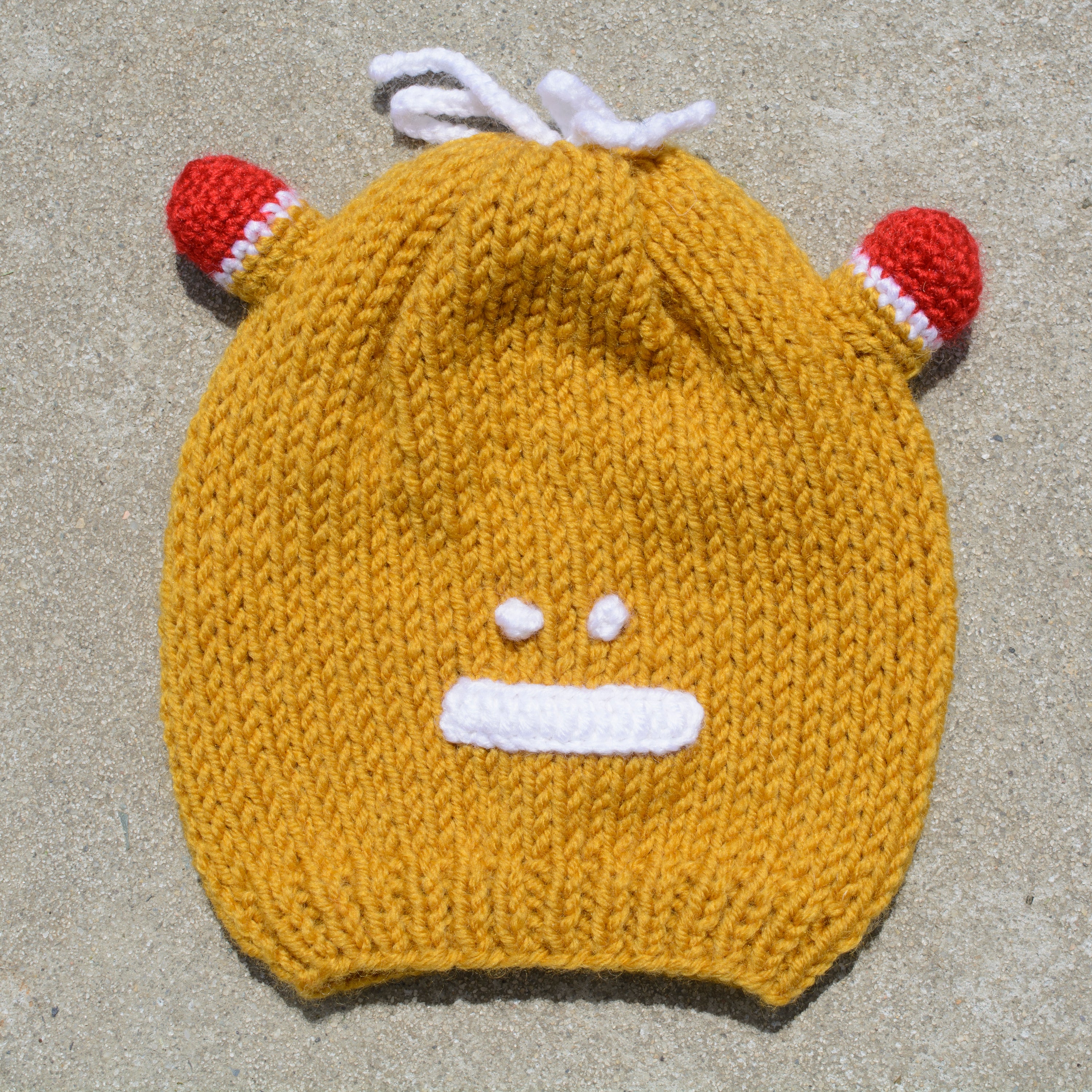 Hand-knitted frog wool beanie cap for kids, featuring a playful design and cozy fit, perfect for ages 2-7.