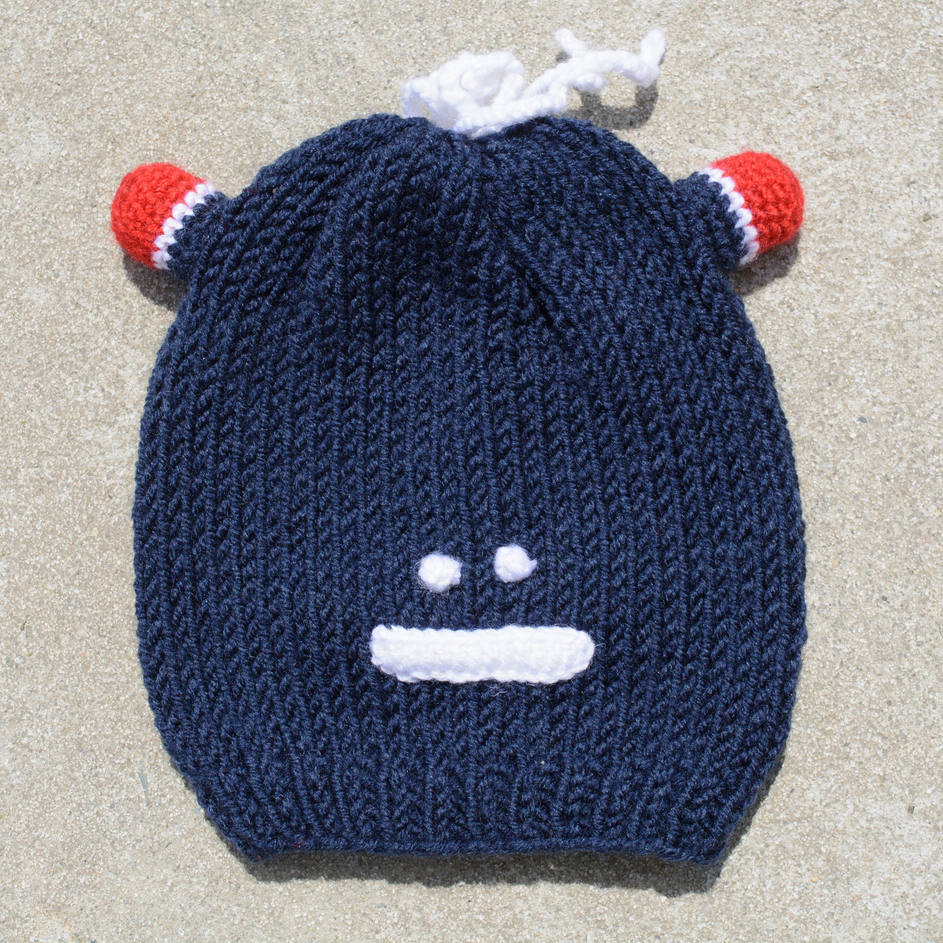 Hand-knitted frog wool beanie cap for kids, featuring a playful design and cozy fit, perfect for ages 2-7.