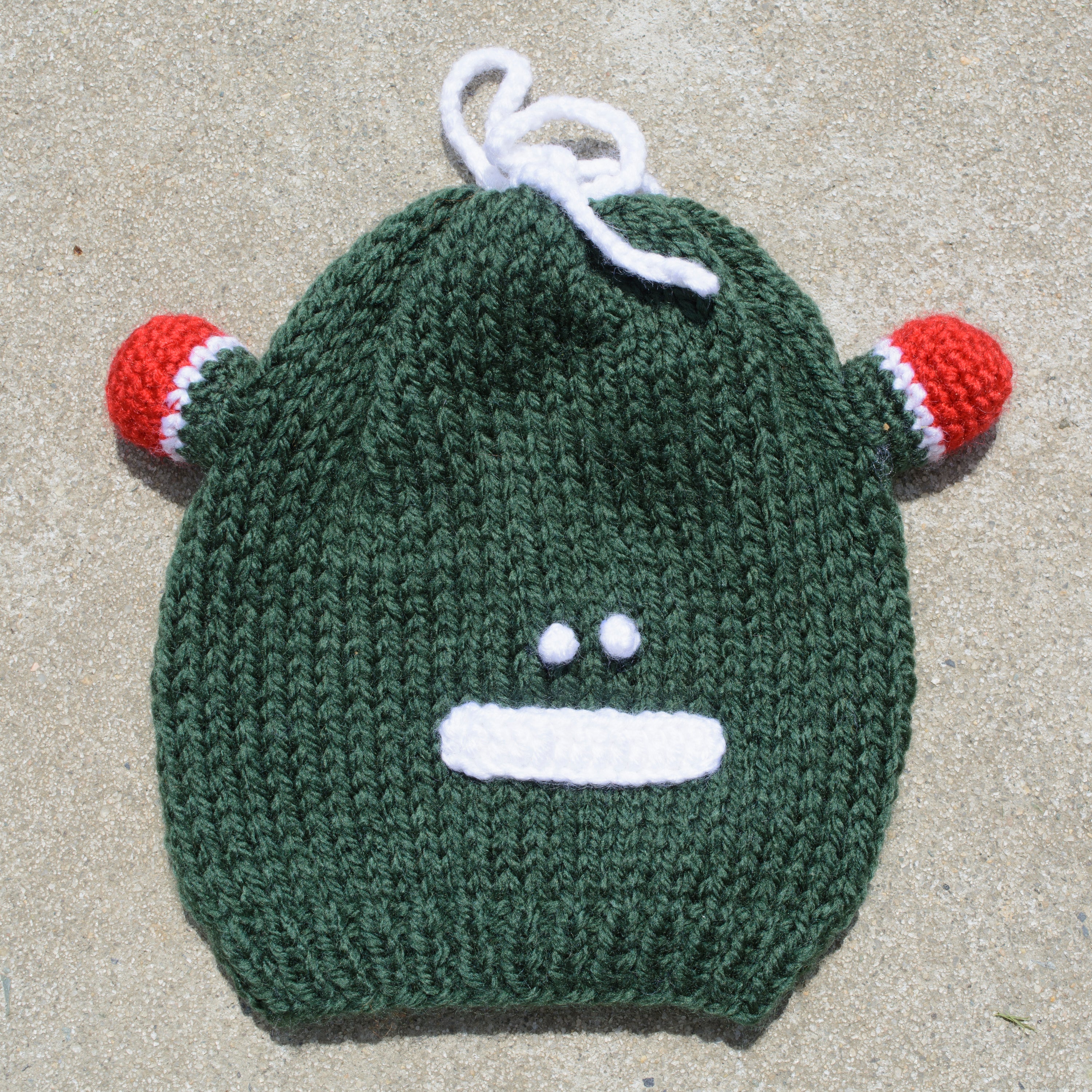 Hand-knitted frog wool beanie cap for kids, featuring a playful design and cozy fit, perfect for ages 2-7.