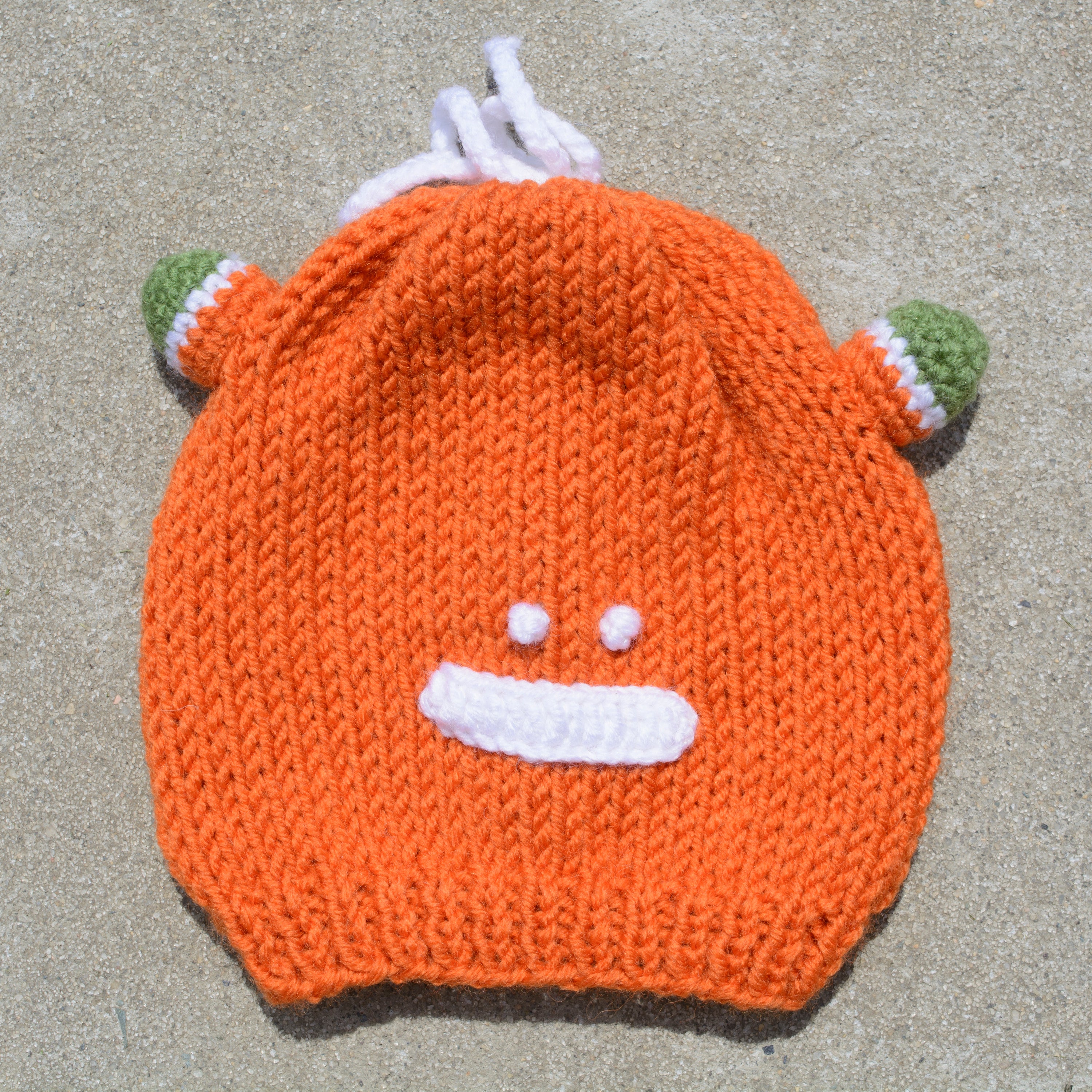 Hand-knitted frog wool beanie cap for kids, featuring a playful design and cozy fit, perfect for ages 2-7.