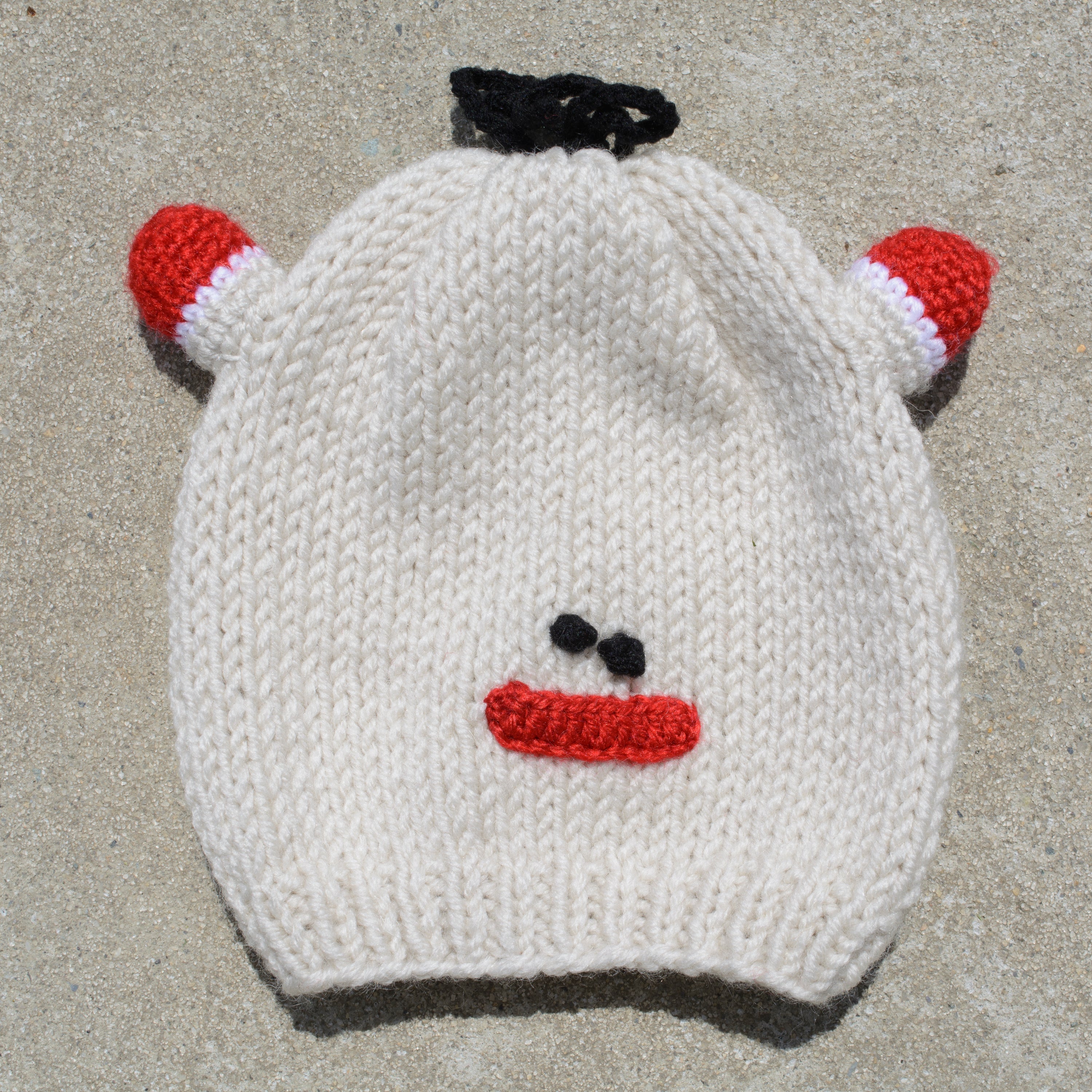 Hand-knitted frog wool beanie cap for kids, featuring a playful design and cozy fit, perfect for ages 2-7.