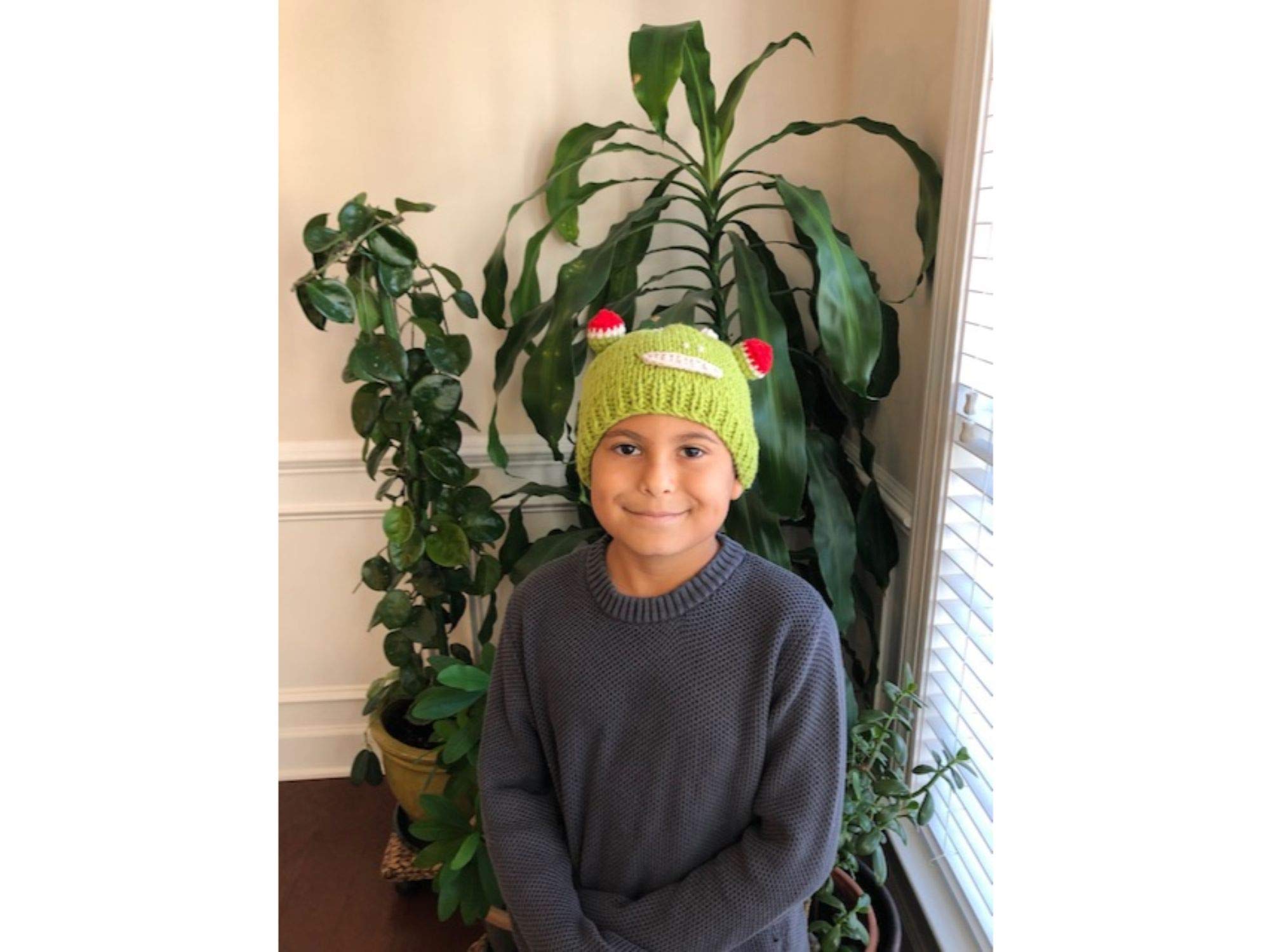 Hand-knitted frog wool beanie cap for kids, featuring a playful design and cozy fit, perfect for ages 2-7.