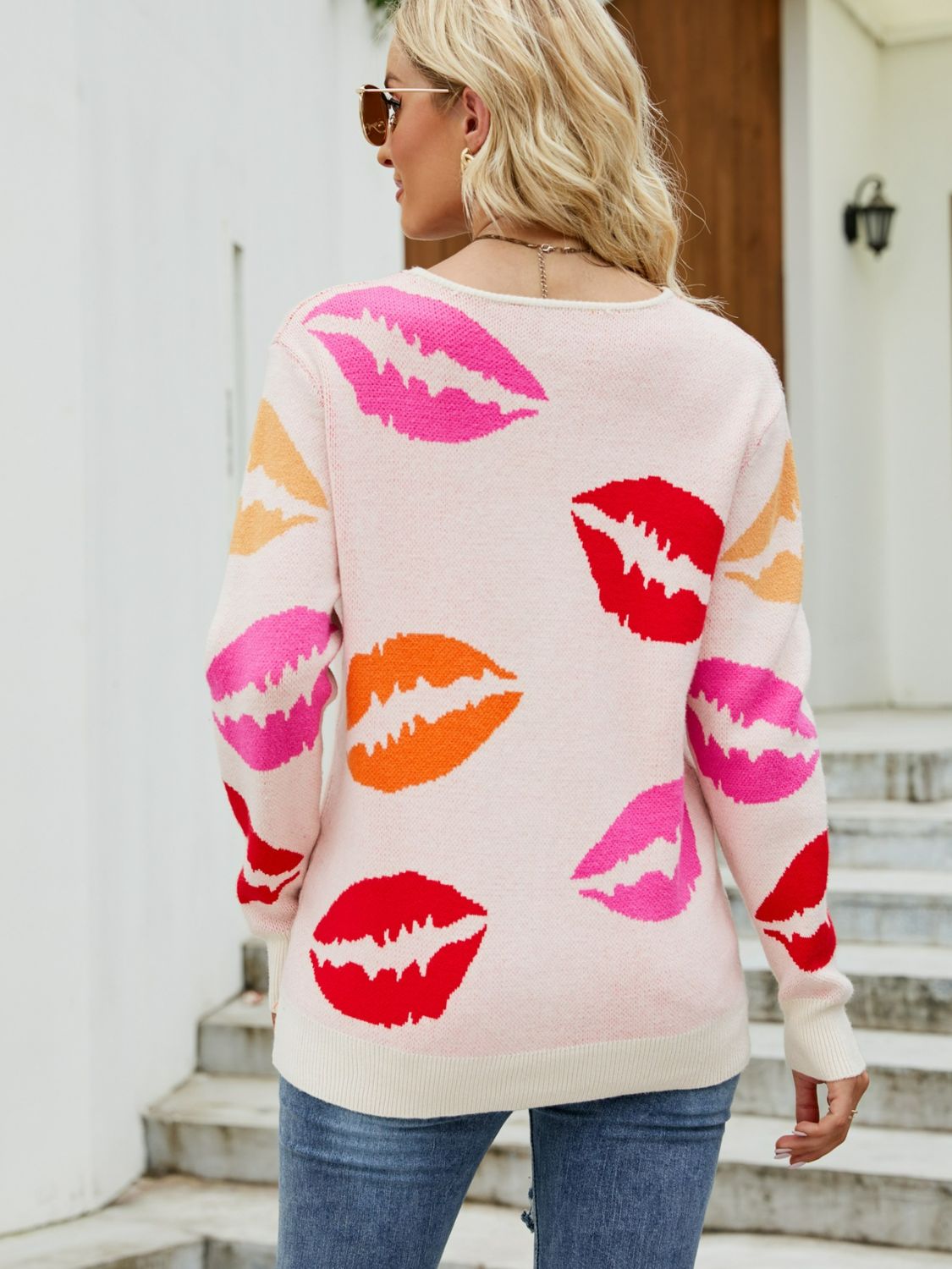 Kisses All Over women's top featuring a V-neck, long sleeves, and a ribbed texture, perfect for casual outdoor wear.