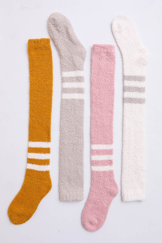 A pair of stylish knee-high boucle socks made from a soft polyester blend, featuring a textured design for added elegance.