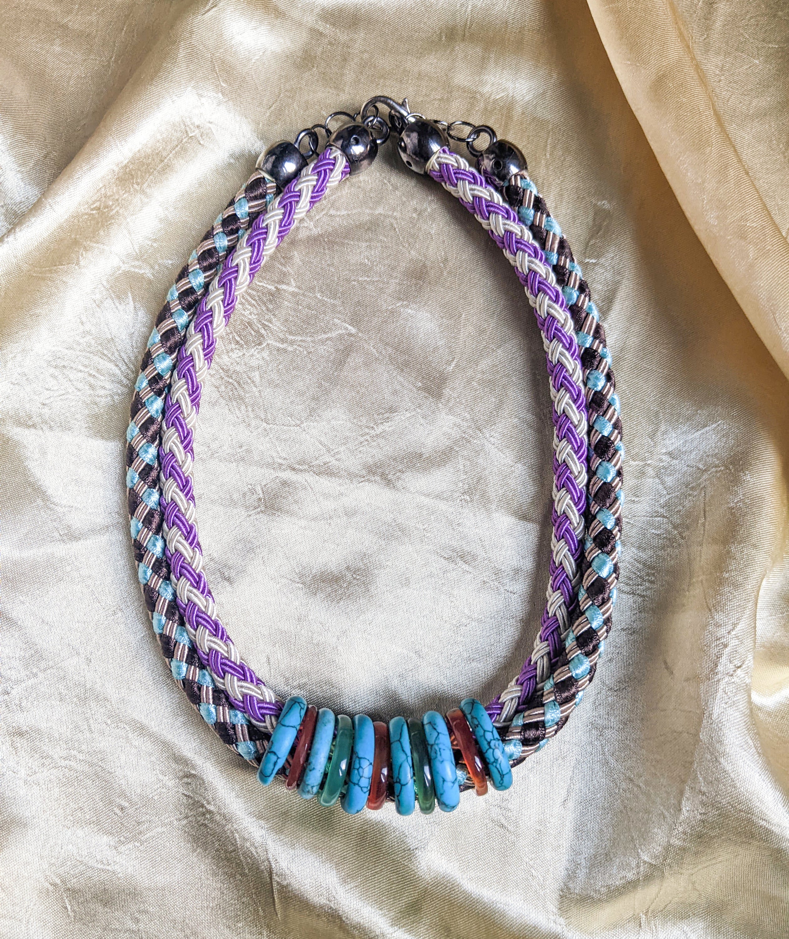 Knit rope choker featuring colorful rings in a double collar design, showcasing vibrant colors and a stylish look.