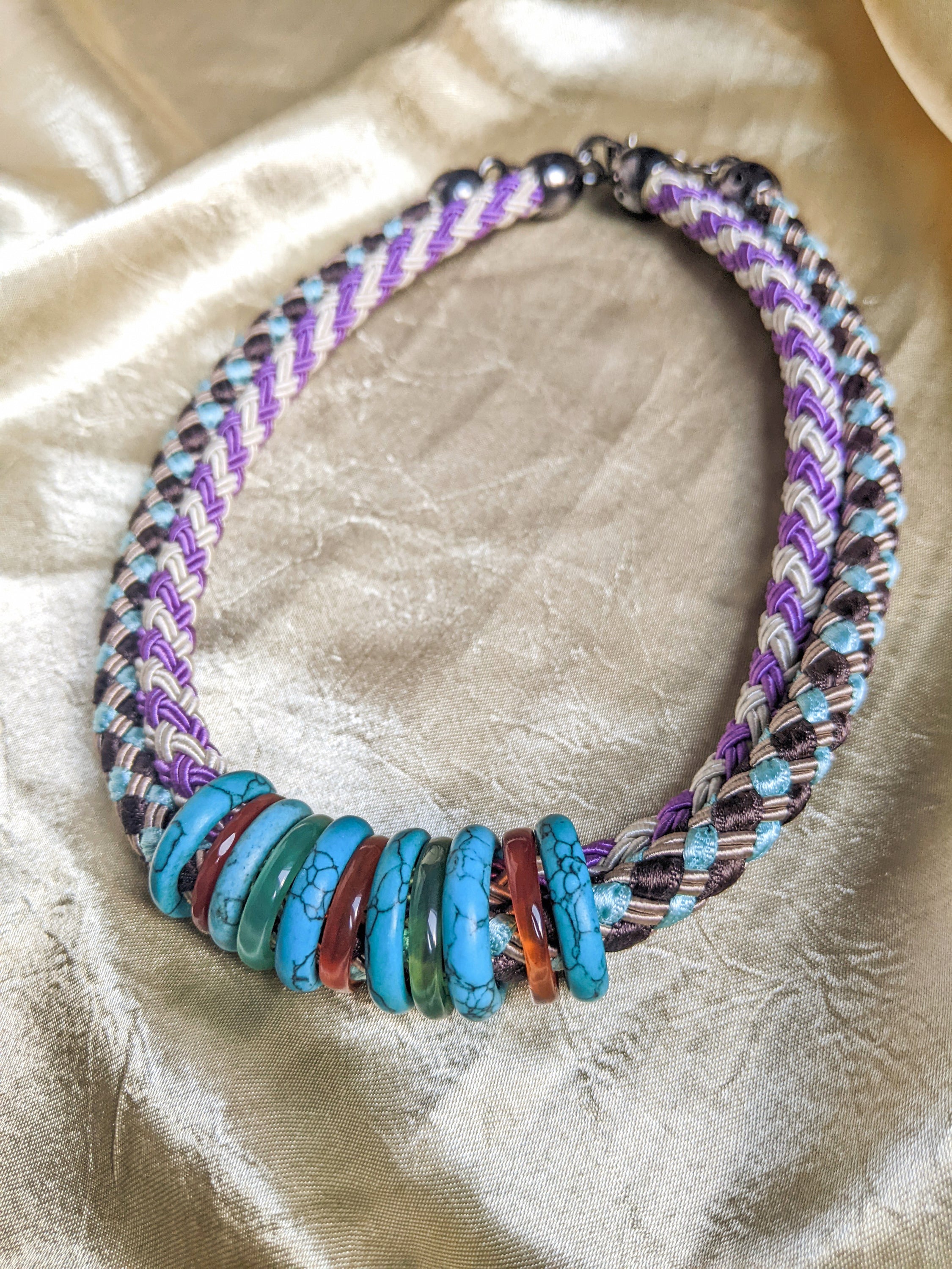 Knit rope choker featuring colorful rings in a double collar design, showcasing vibrant colors and a stylish look.