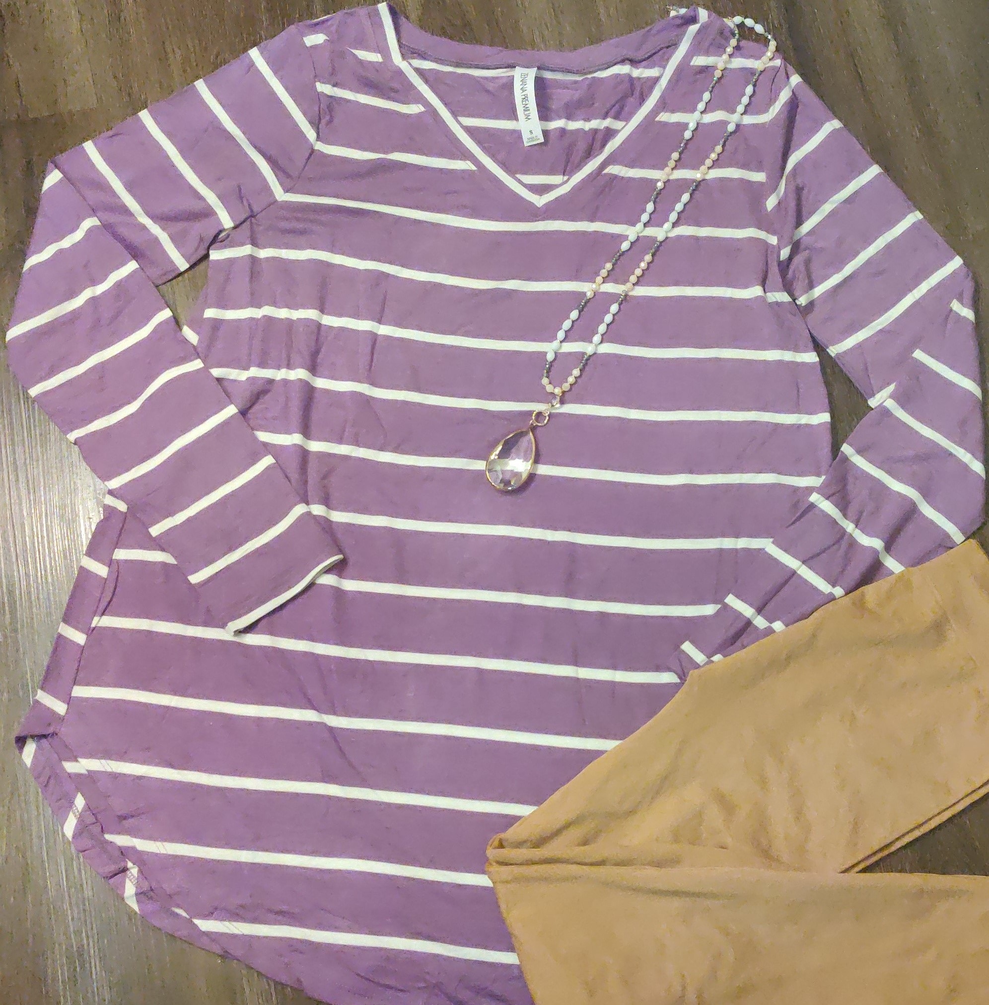 A stylish purple knit striped tunic perfect for spring, featuring a comfortable fit and versatile design.