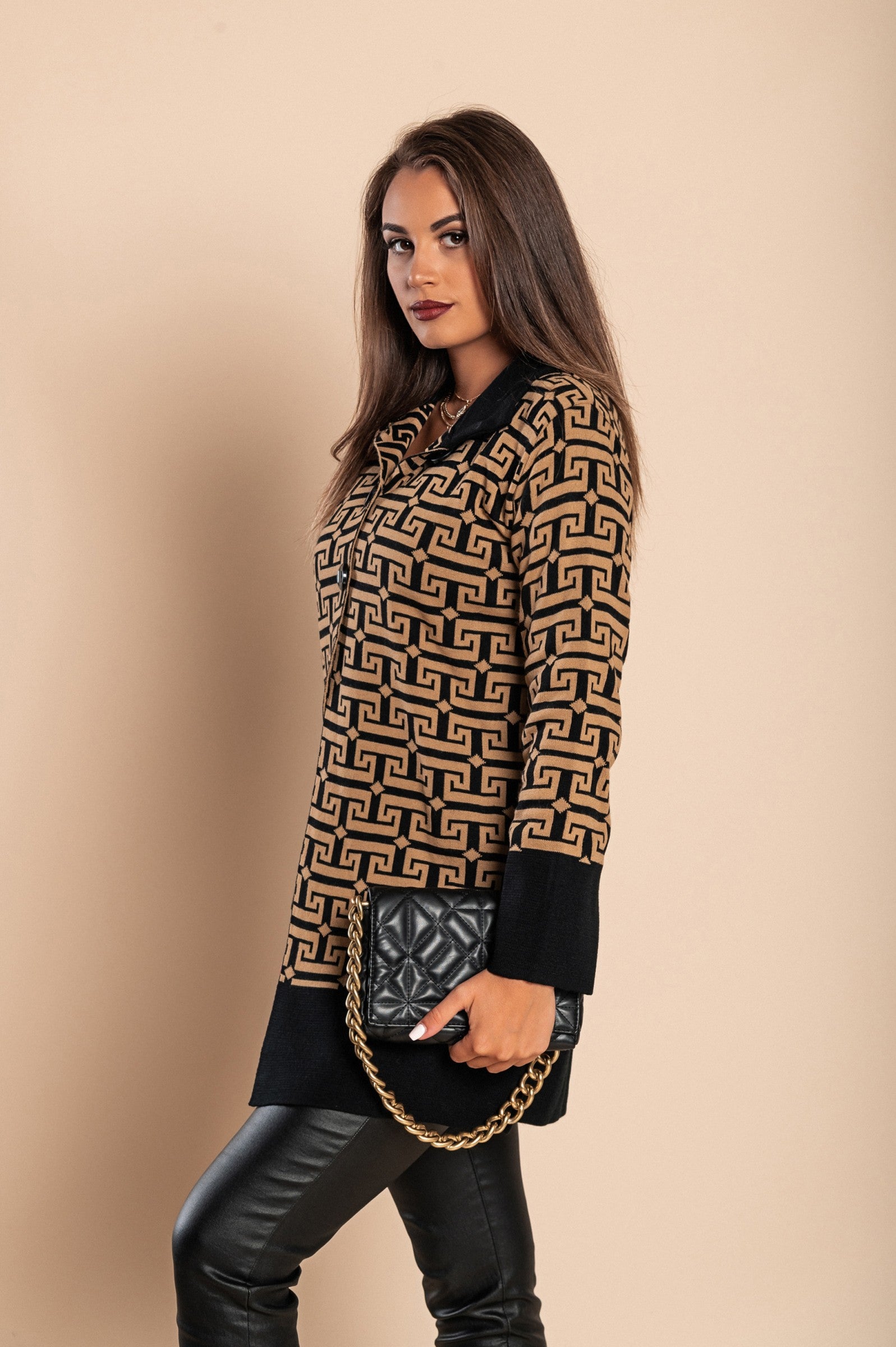 Elegant black knitted cardigan with geometric pattern, featuring long sleeves and high collar, made from wool and acrylic blend.