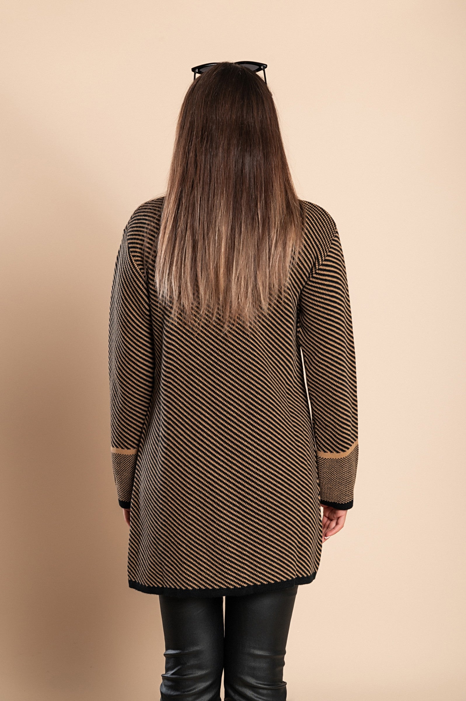 Elegant black knitted cardigan with a unique pattern, featuring long sleeves, a high collar, and button fastening.