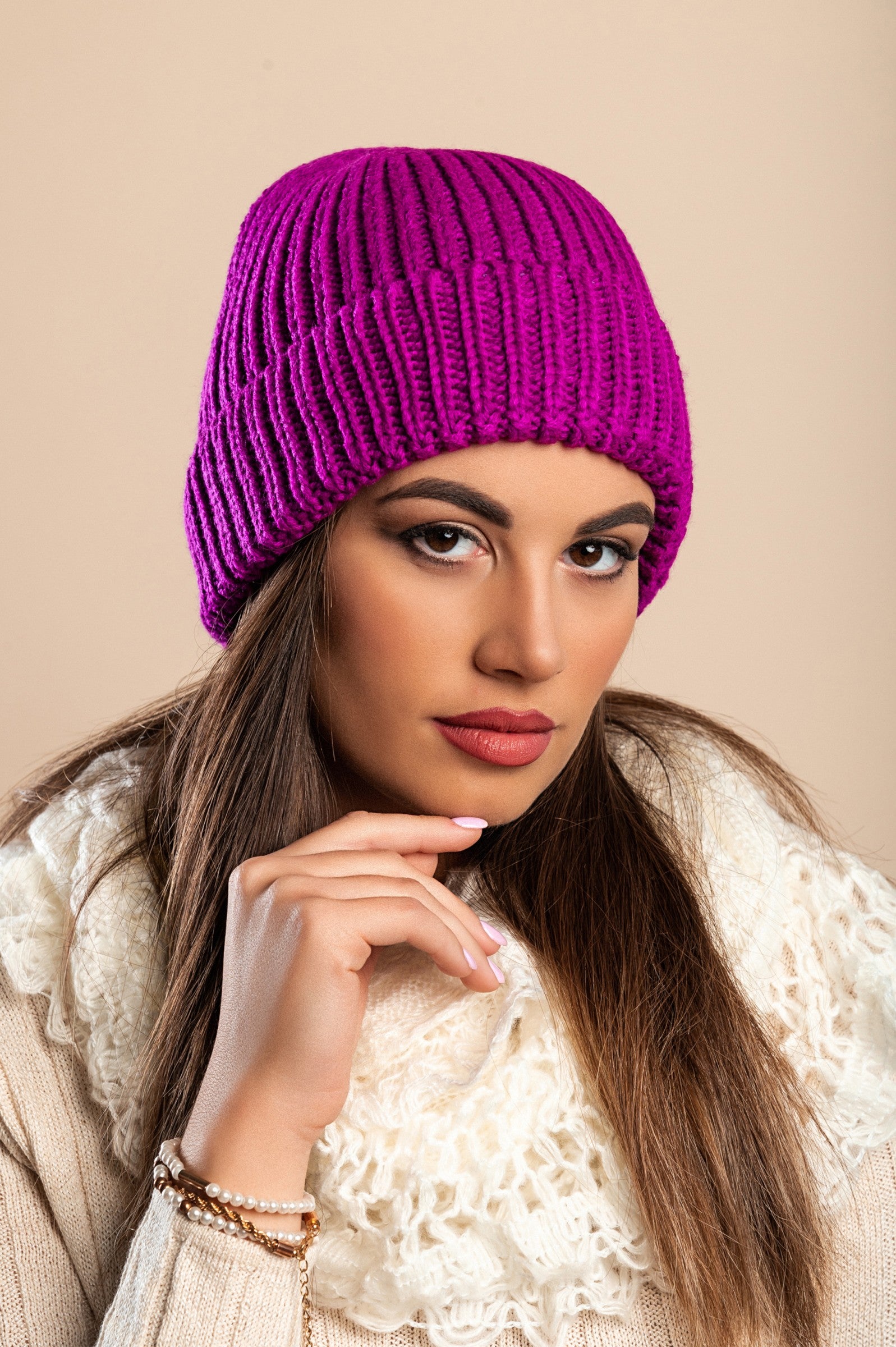 A stylish cyclamen knitted hat with a ribbed knit design and rolled hem, perfect for winter wear.