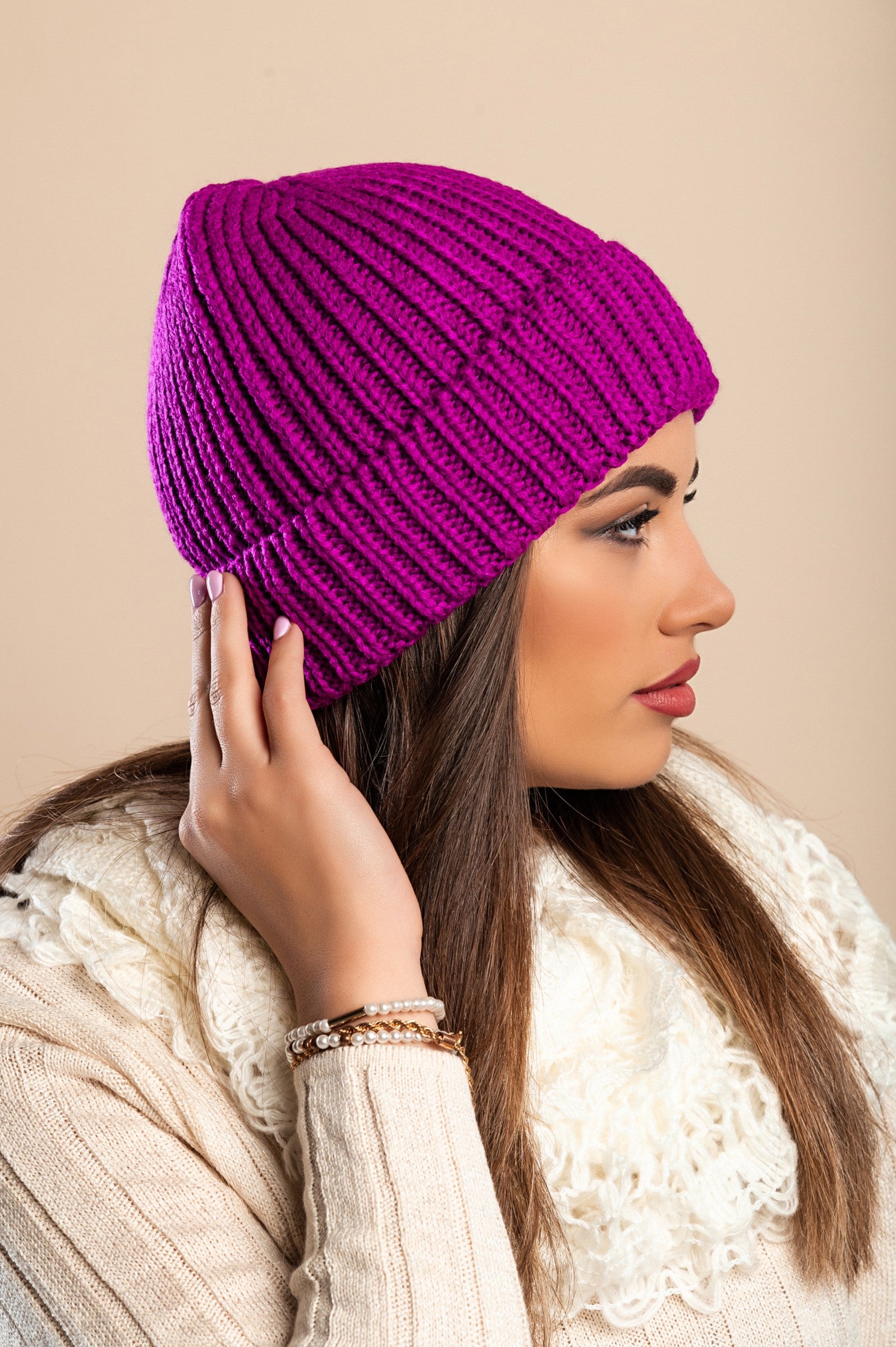 A stylish cyclamen knitted hat featuring a ribbed knit design and rolled hem, perfect for winter wear.