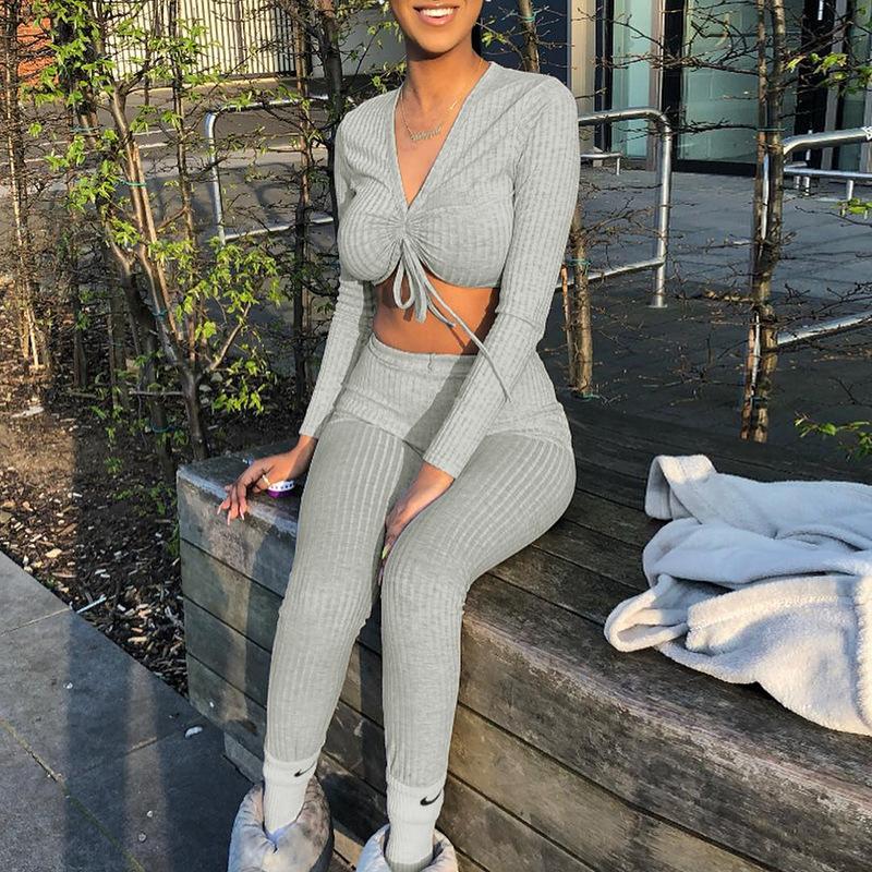 A stylish gray knitted long sleeve jumpsuit for women featuring a lace-up design, perfect for clubbing and casual outings.