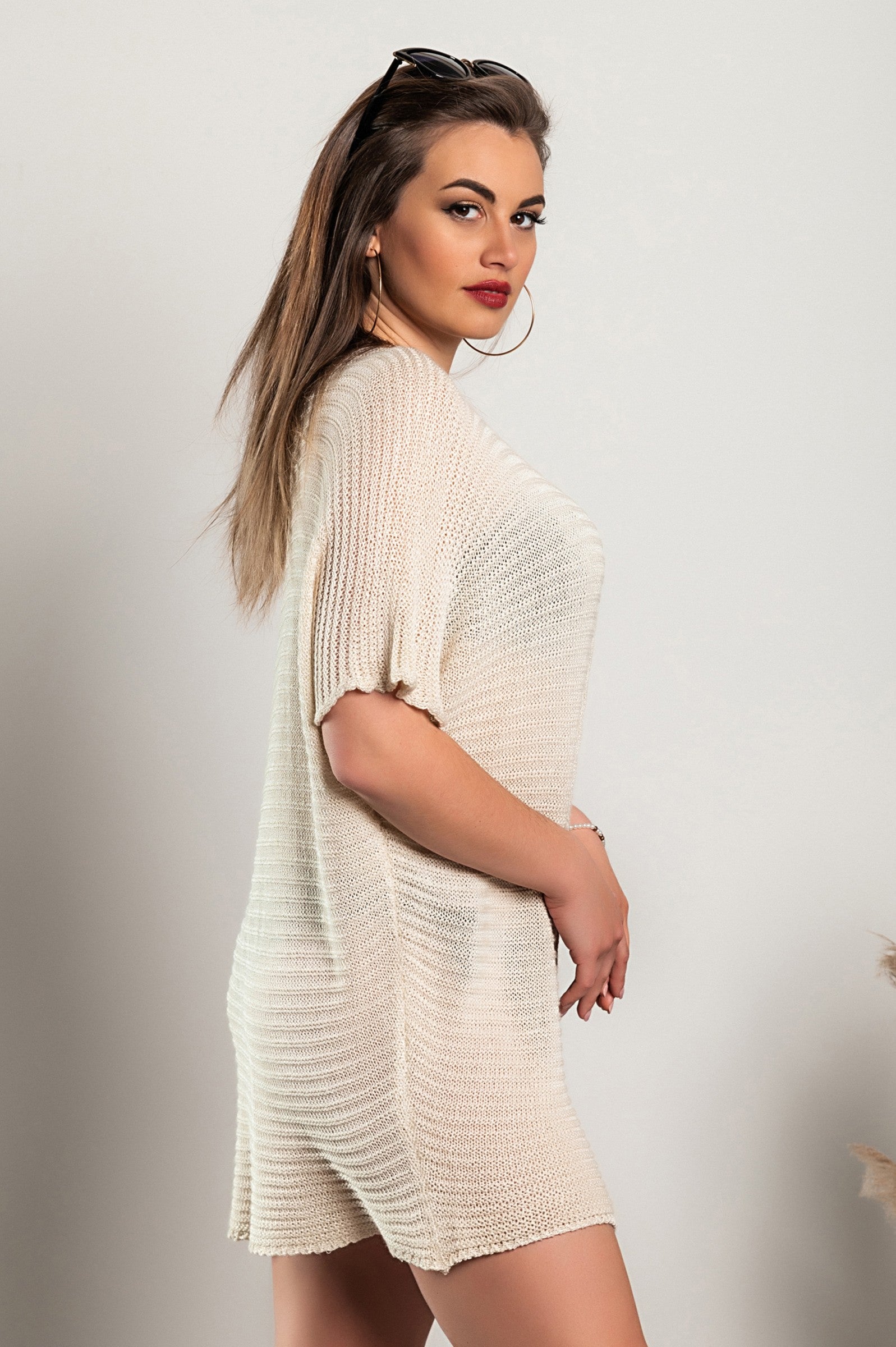 Cream knitted mini dress with short sleeves, featuring a loose fit and wide neckline, made in Italy.