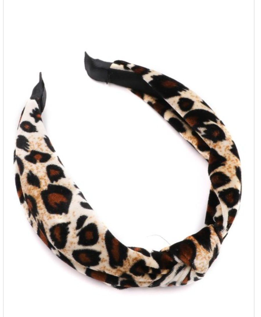 A stylish knotted leopard print headband designed for comfort and fashion, featuring a unique knot detail.