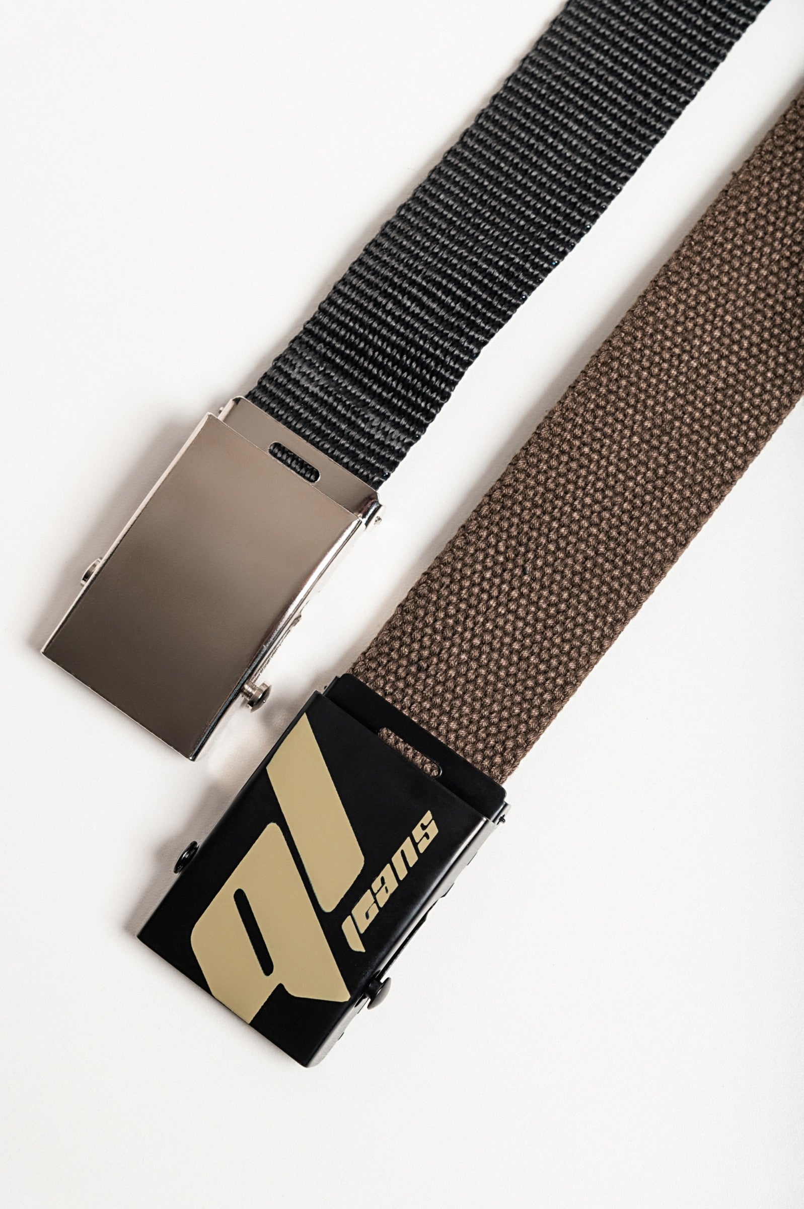 Set of two adjustable belts in brown and black with metal buckles, showcasing durability and style.