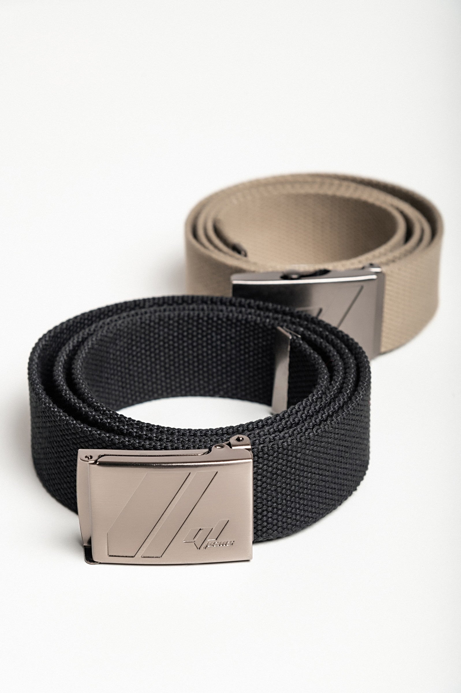 Two-piece belt set in black and olive with metal buckle, showcasing durability and style.