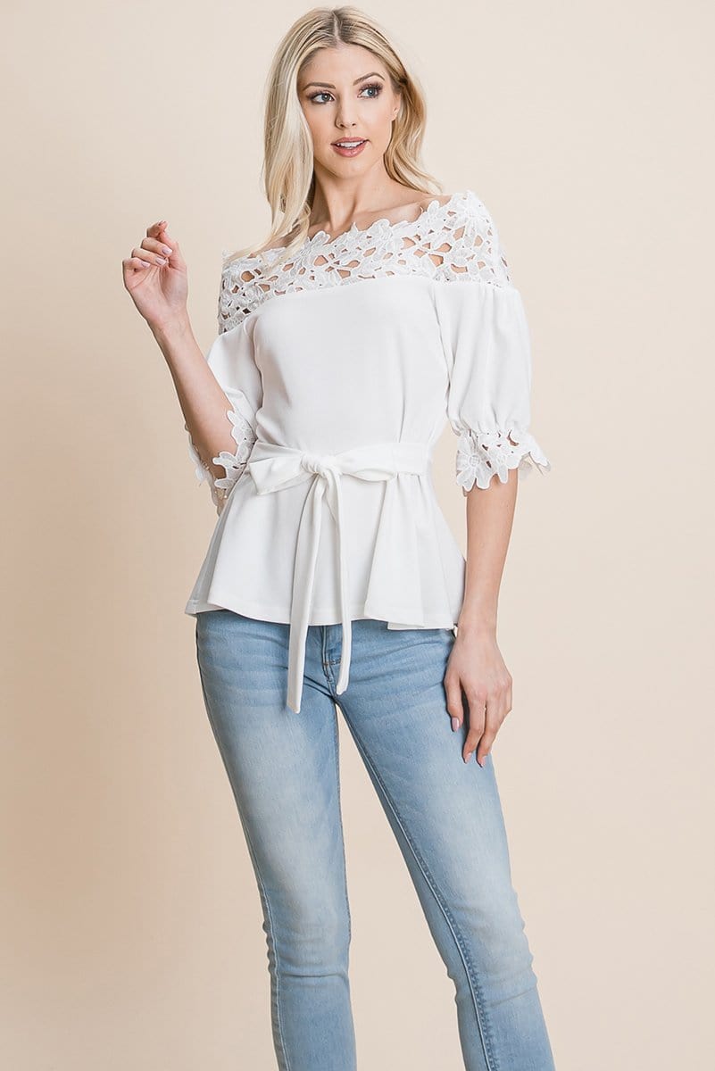 A stylish Lace Crochet Self Belted Off The Shoulder Top featuring floral lace applique, half lace trim sleeves, and a hidden back zipper.