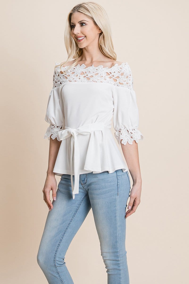 A stylish Lace Crochet Self Belted Off The Shoulder Top featuring floral lace applique, half lace trim sleeves, and a hidden back zipper.