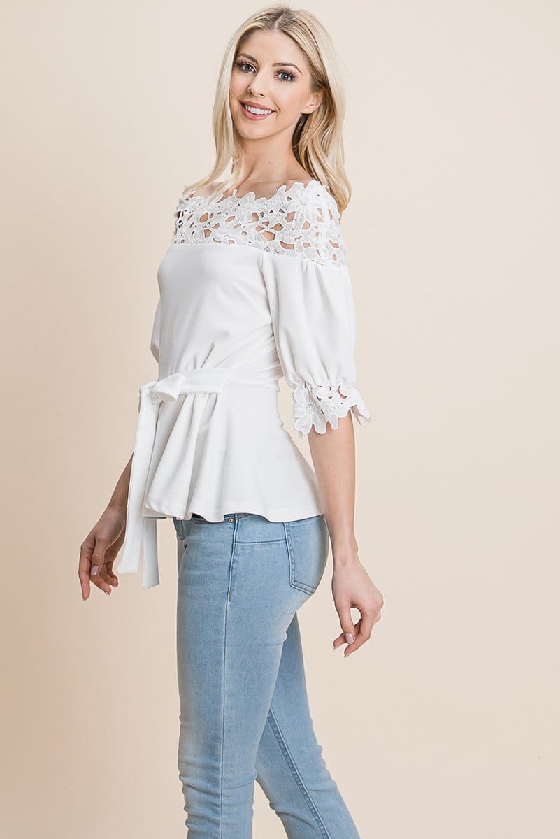 A stylish Lace Crochet Self Belted Off The Shoulder Top featuring floral lace applique, half lace trim sleeves, and a hidden back zipper.