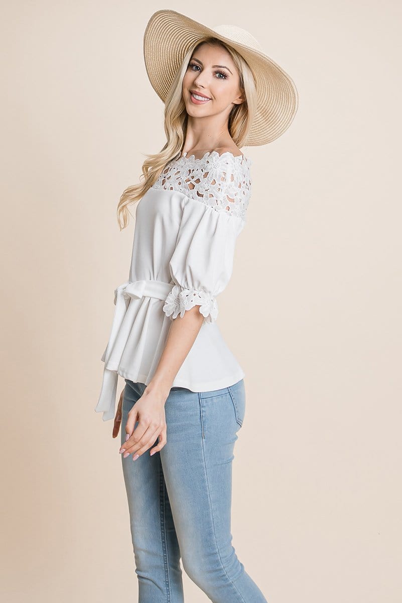 A stylish Lace Crochet Self Belted Off The Shoulder Top featuring floral lace applique, half lace trim sleeves, and a hidden back zipper.