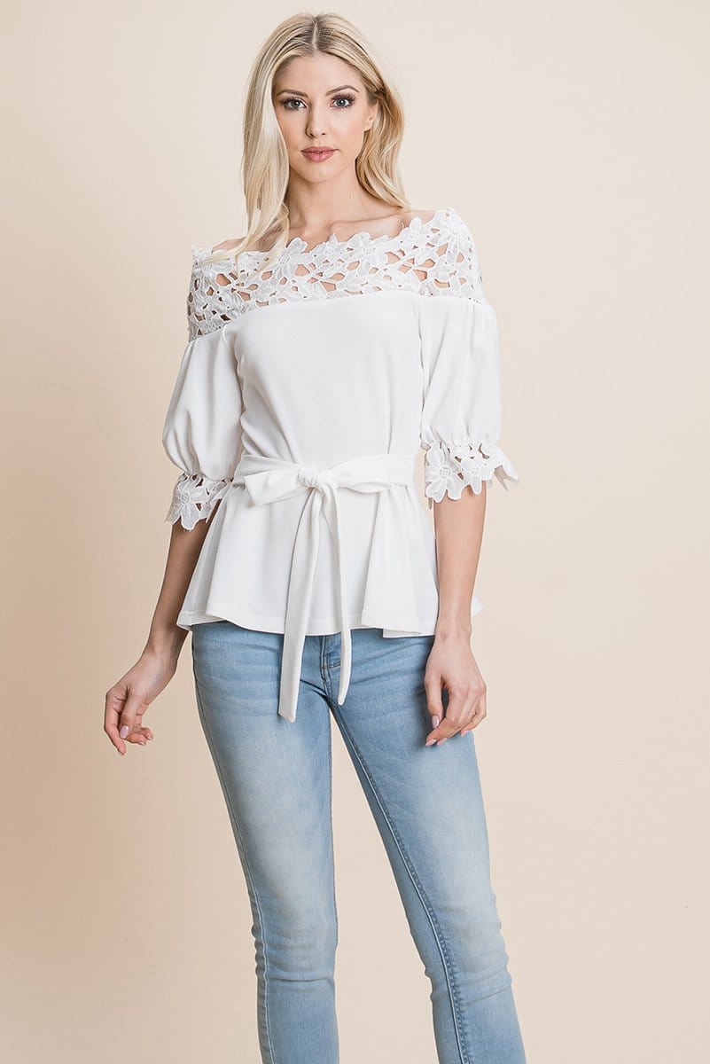 A stylish Lace Crochet Self Belted Off The Shoulder Top featuring floral lace applique, half lace trim sleeves, and a hidden back zipper.