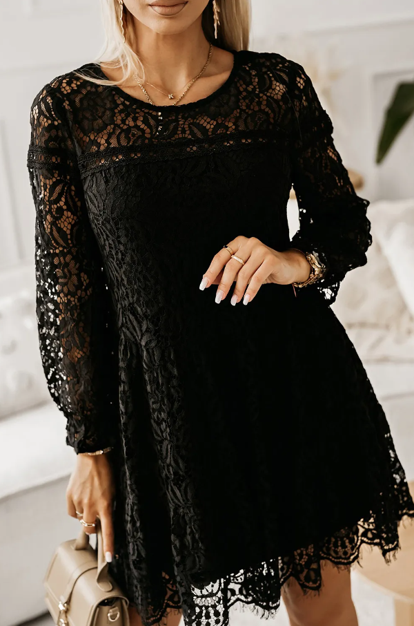 A stylish black lace mini dress featuring a round neck, long sleeves, and a button closure at the back, made from sheer lace material.