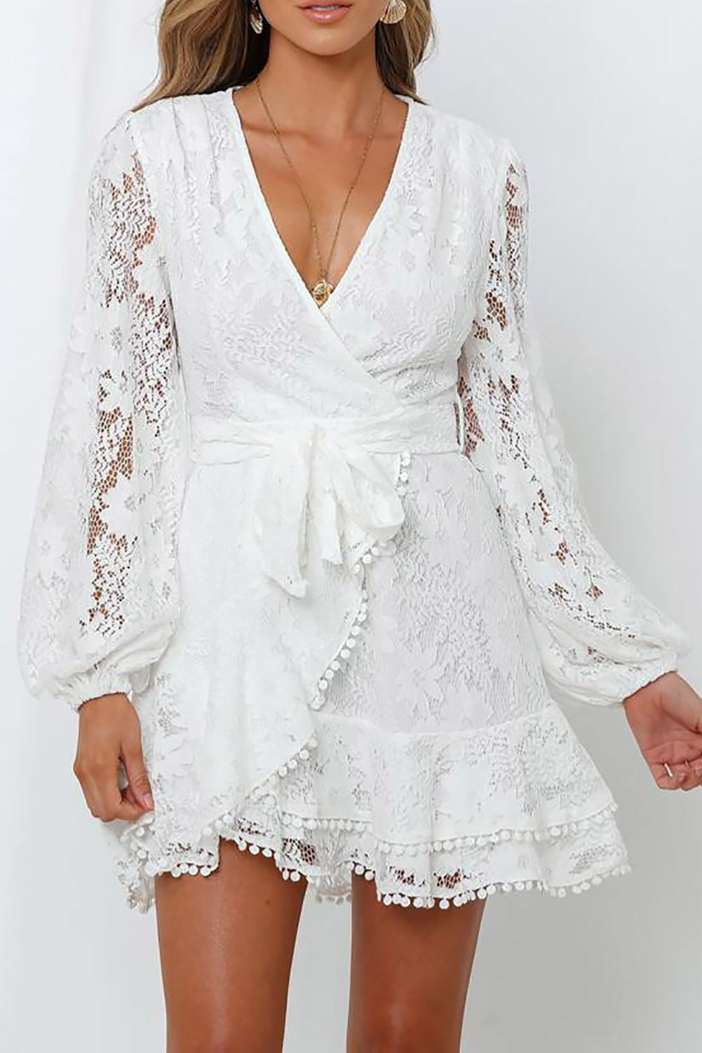 White Lace Minidress Ginestre featuring a deep neckline, long sleeves, and ruffled skirt, perfect for summer occasions.