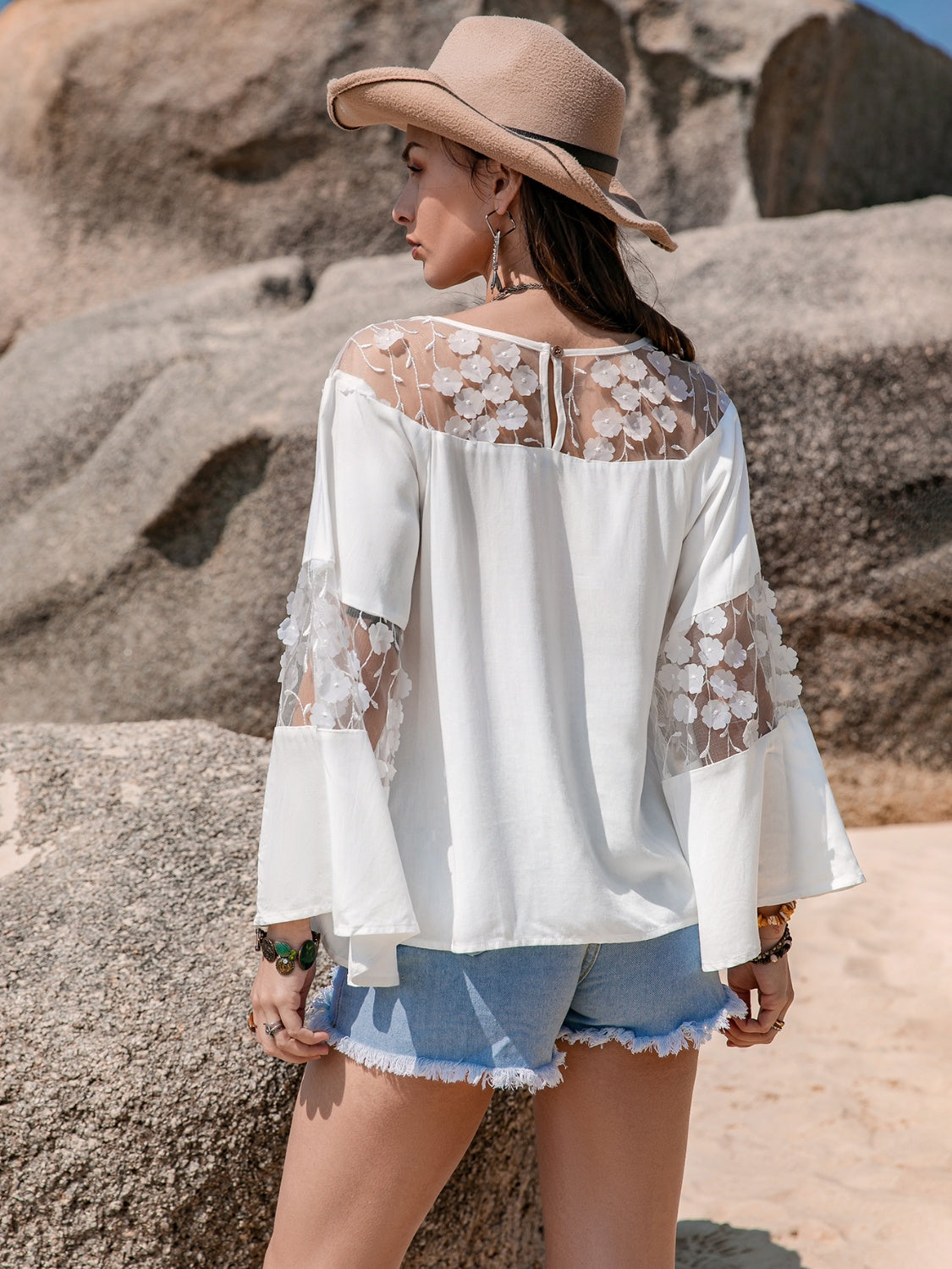 Lace Round Neck Long Sleeve Blouse featuring intricate lace detail and semi-sheer fabric, perfect for stylish occasions.