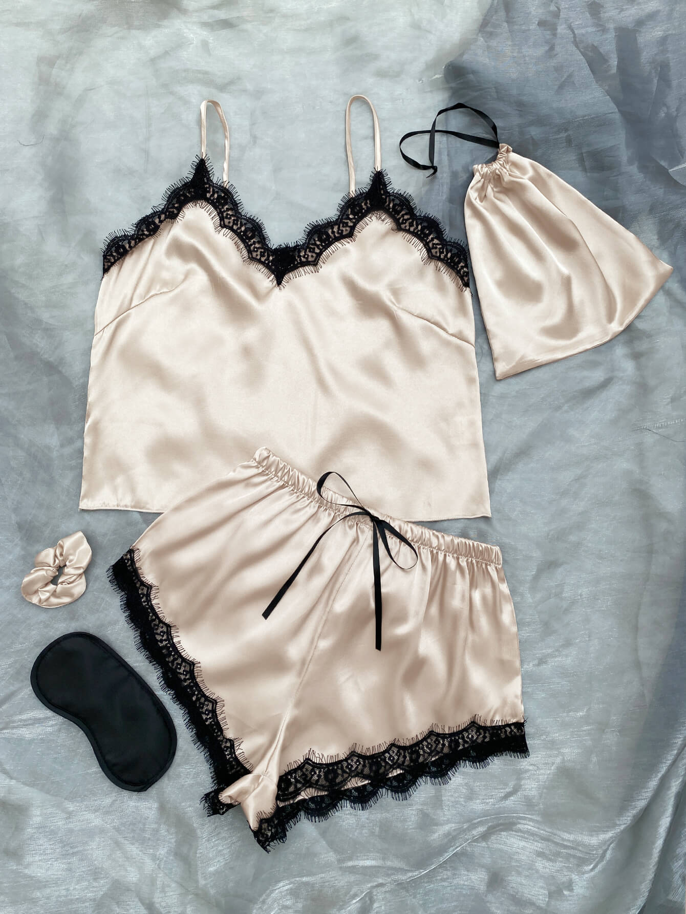 Lace Trim Cami, Shorts, Eye Mask, Scrunchie, and Bag Pajama Set displayed in a flat lay style, showcasing the elegant satin fabric and lace details.