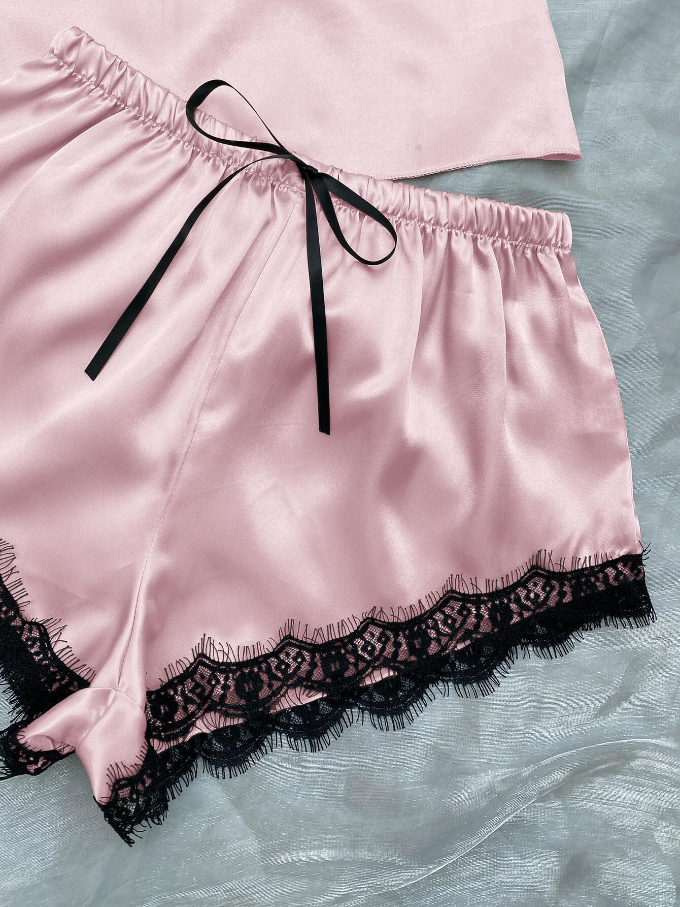 Lace Trim Cami, Shorts, Eye Mask, Scrunchie, and Bag Pajama Set displayed in a flat lay style, showcasing the elegant satin fabric and lace details.