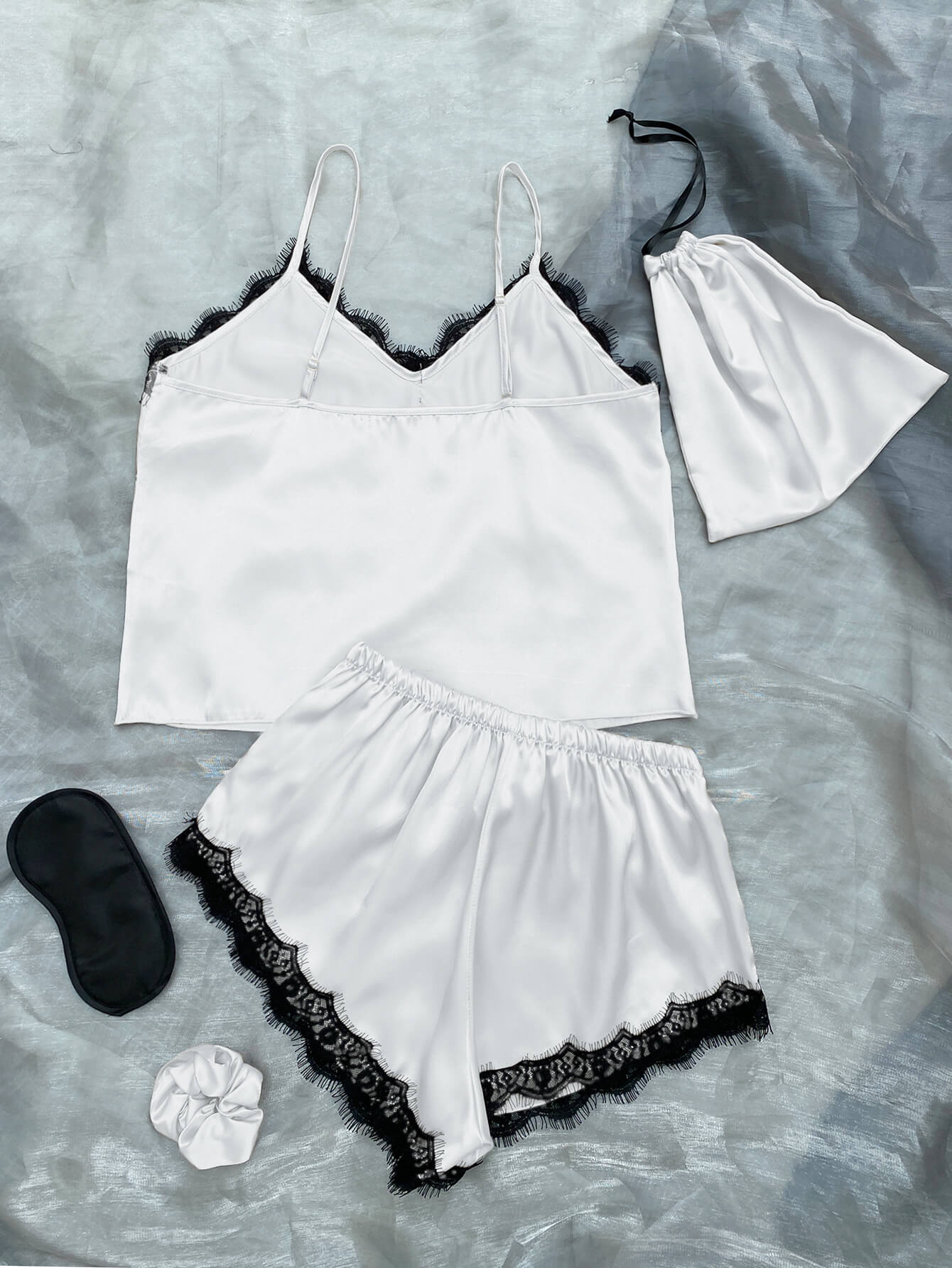 Lace Trim Cami, Shorts, Eye Mask, Scrunchie, and Bag Pajama Set displayed in a flat lay style, showcasing the elegant satin fabric and lace details.