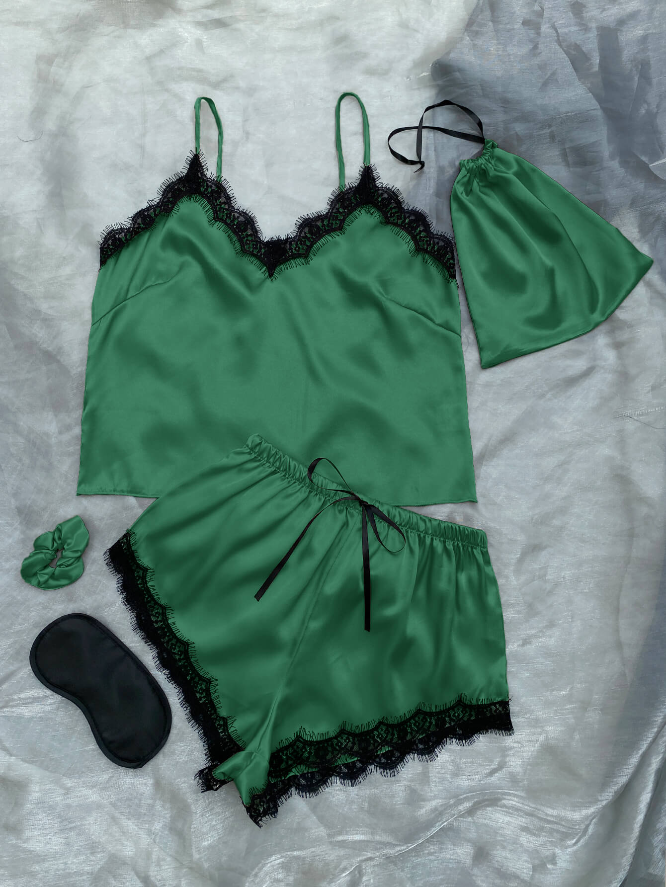 Lace Trim Cami, Shorts, Eye Mask, Scrunchie, and Bag Pajama Set displayed in a flat lay style, showcasing the elegant satin fabric and lace details.