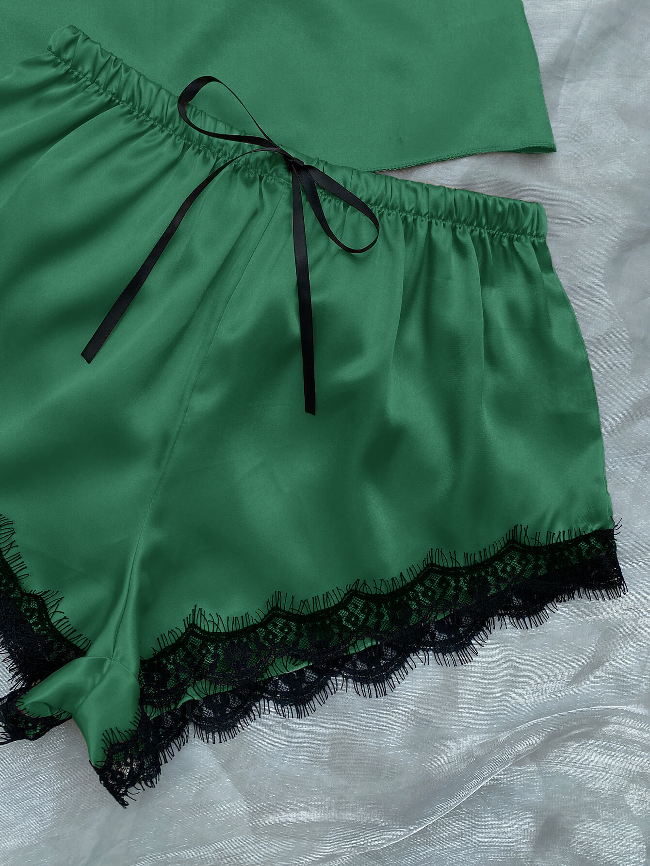 Lace Trim Cami, Shorts, Eye Mask, Scrunchie, and Bag Pajama Set displayed in a flat lay style, showcasing the elegant satin fabric and lace details.