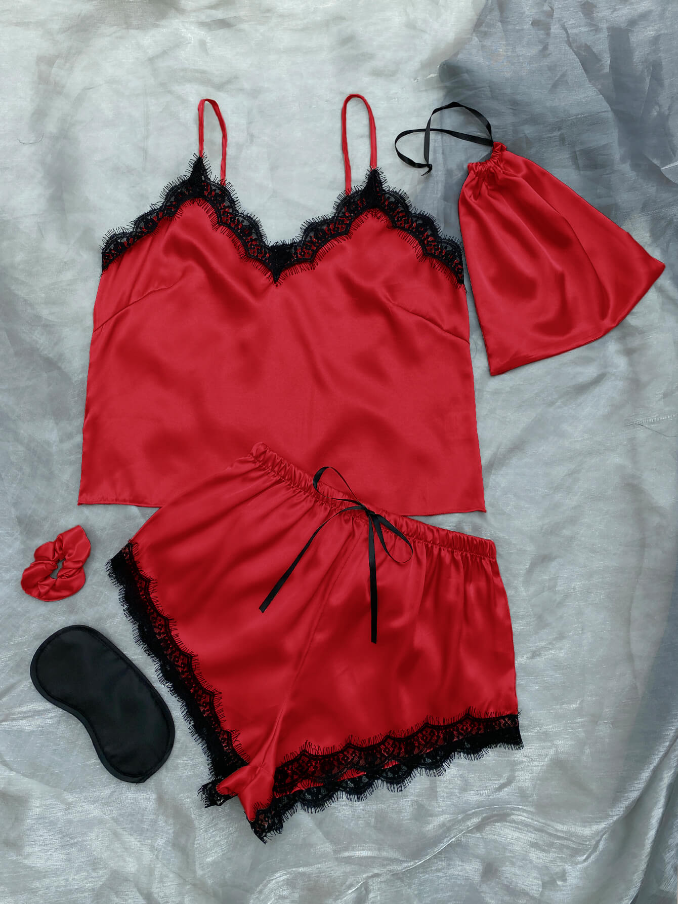 Lace Trim Cami, Shorts, Eye Mask, Scrunchie, and Bag Pajama Set displayed in a flat lay style, showcasing the elegant satin fabric and lace details.