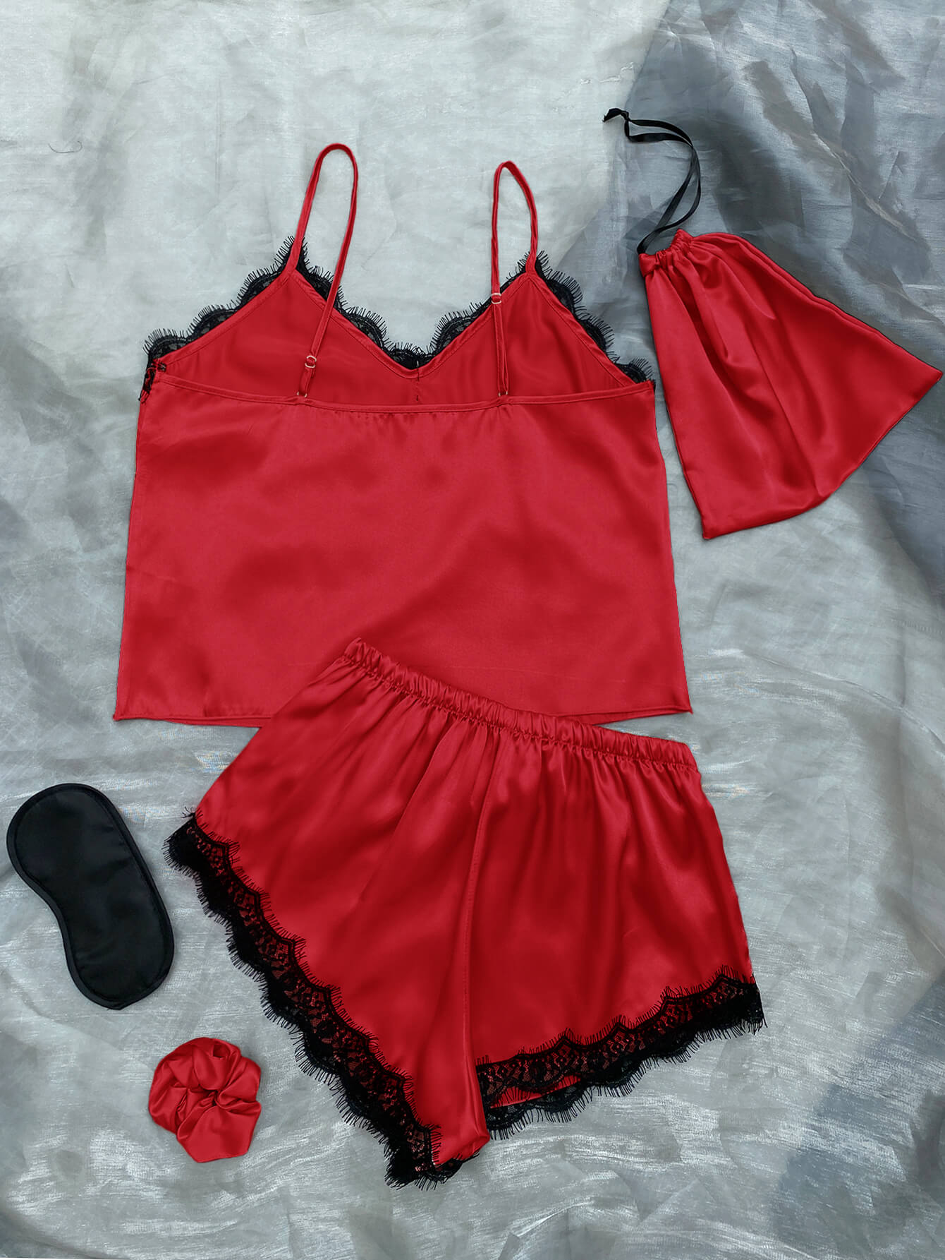 Lace Trim Cami, Shorts, Eye Mask, Scrunchie, and Bag Pajama Set displayed in a flat lay style, showcasing the elegant satin fabric and lace details.