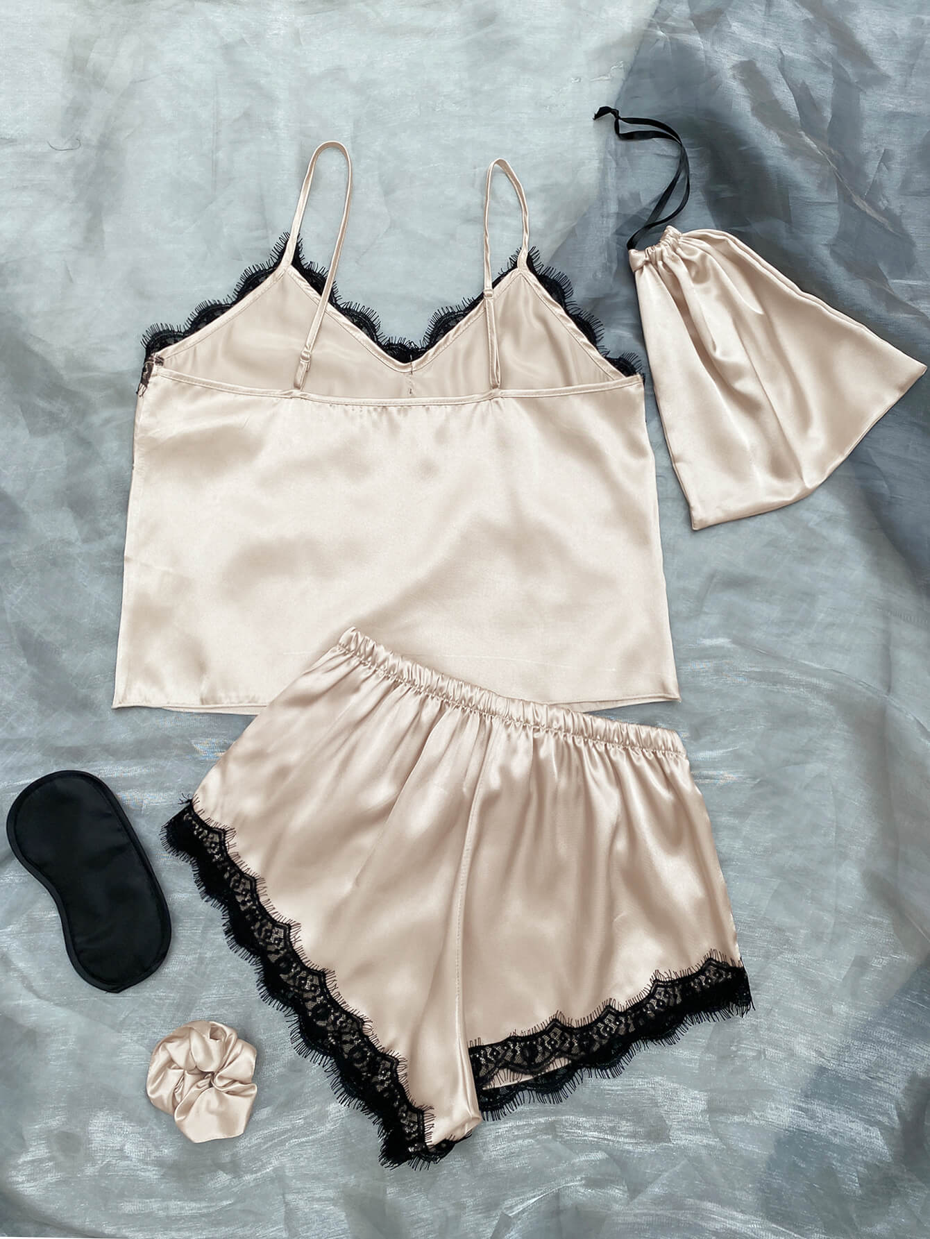 Lace Trim Cami, Shorts, Eye Mask, Scrunchie, and Bag Pajama Set displayed in a flat lay style, showcasing the elegant satin fabric and lace details.