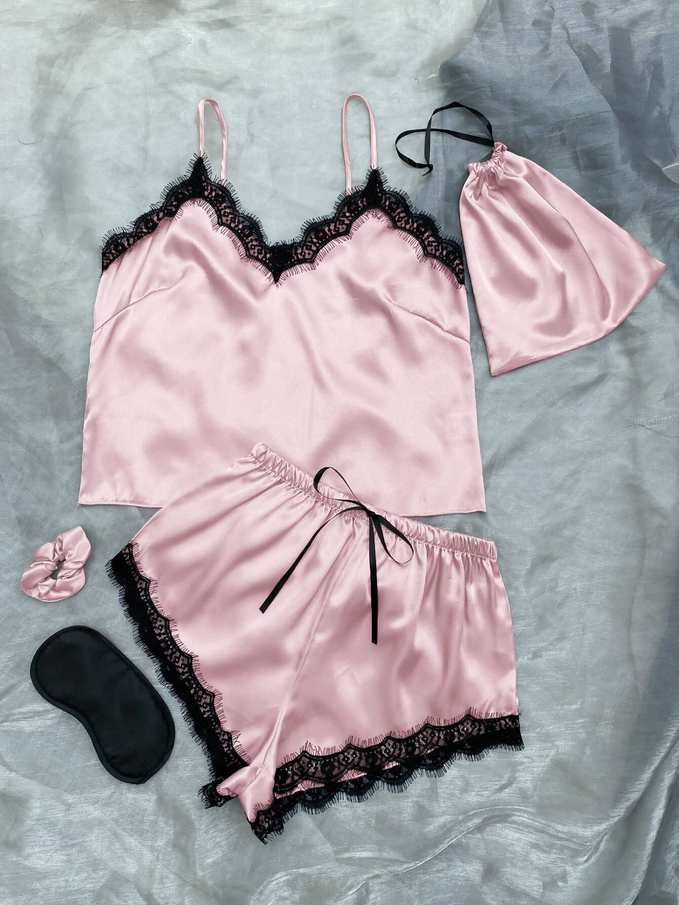 Lace Trim Cami, Shorts, Eye Mask, Scrunchie, and Bag Pajama Set displayed in a flat lay style, showcasing the elegant satin fabric and lace details.